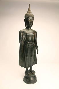 Large Thai Bronze Buddha: Northern Thailand; c. 17th century. Standing bronze figure of Buddha on integral circular base. Eyes inlaid with mother of pearl. Well defined features, good example. Height; 28.5" (72.3 cm)