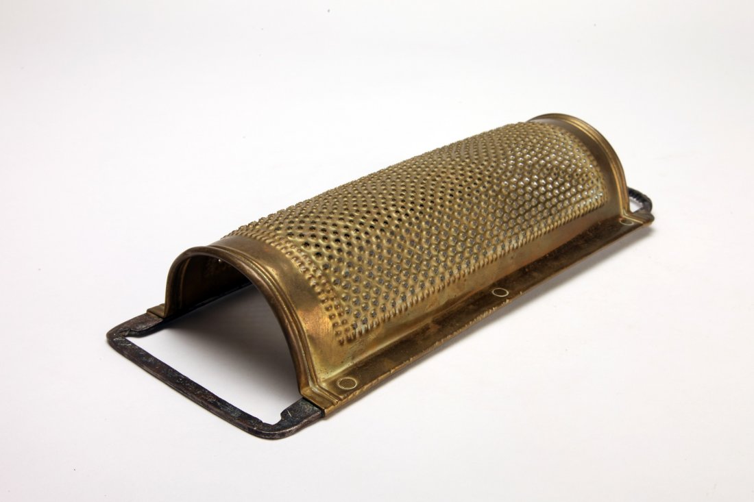 George III Pierced Brass and Iron Kitchen Grater: England, c. 1800; The semi cylindrical grater mounted on an iron frame with twisted handle. Length: 12 7/8" (32.7cm)