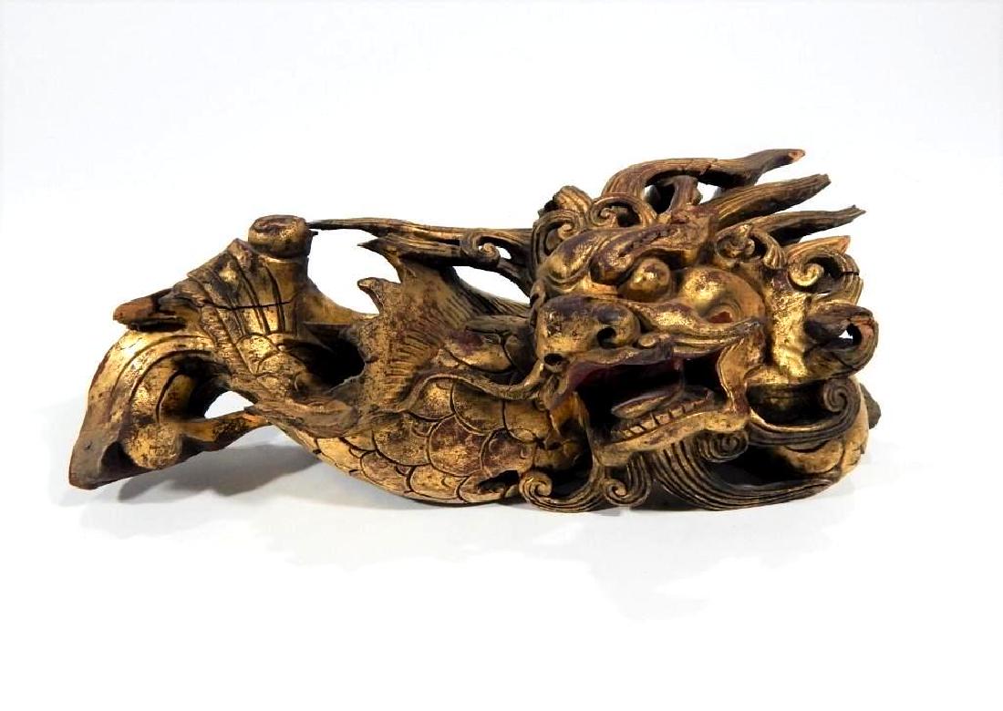 Chinese Carved Dragon Wood Element: China, 19th century. Finely carved gilt wood carved dragon. Some losses. Measures 11" x 4.25"