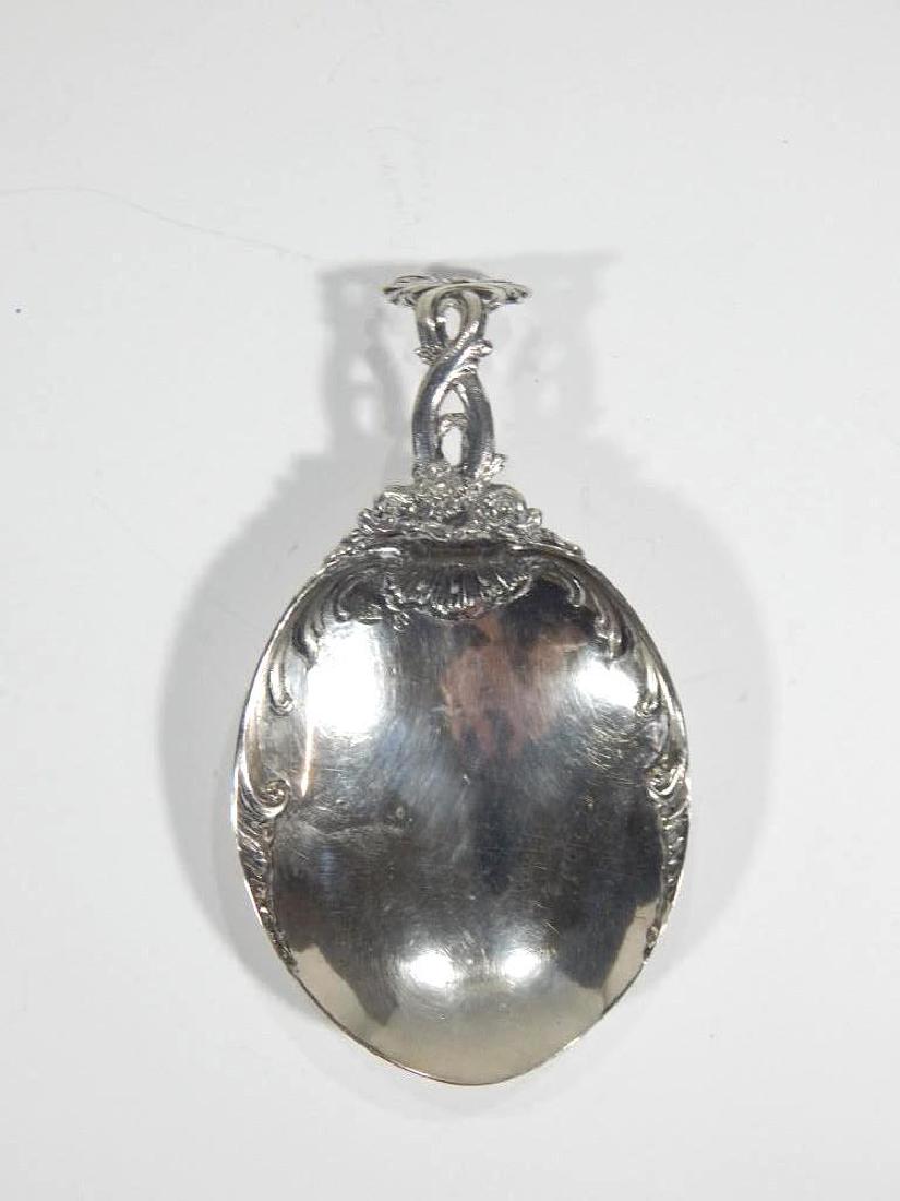 Early Sterling Silver Spoon with Shoe Rests: An early sterling silver spoon with scrolled handle and miniature shoe rests, unmarked. 5.5" x 3"