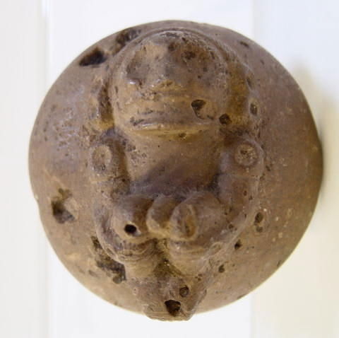 474A Taino Stone Body Stamp: Ca. 1000-1500 A.D., Santo Domingo, figural front design with the reverse stamp of circular geometric design, measures 4" diameter.