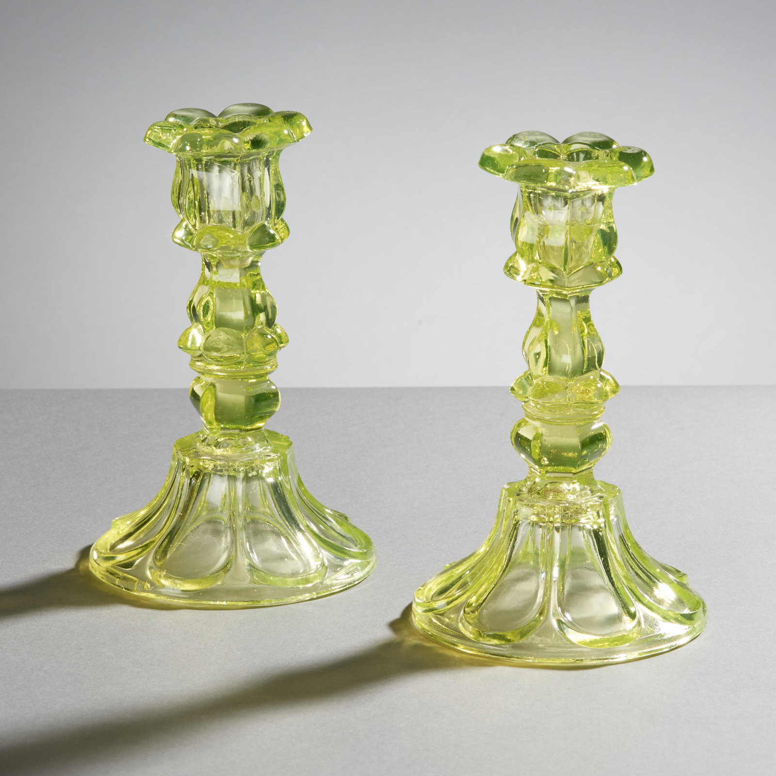 Early Sandwich Glass Canary Petal Loop Candlesticks: Fine pair of early 19th century Sandwich Glass canary yellow petal loop candlesticks. Very good condition, minor imperfections (Chip on one at the top of the petal, chip on second where petals meet an