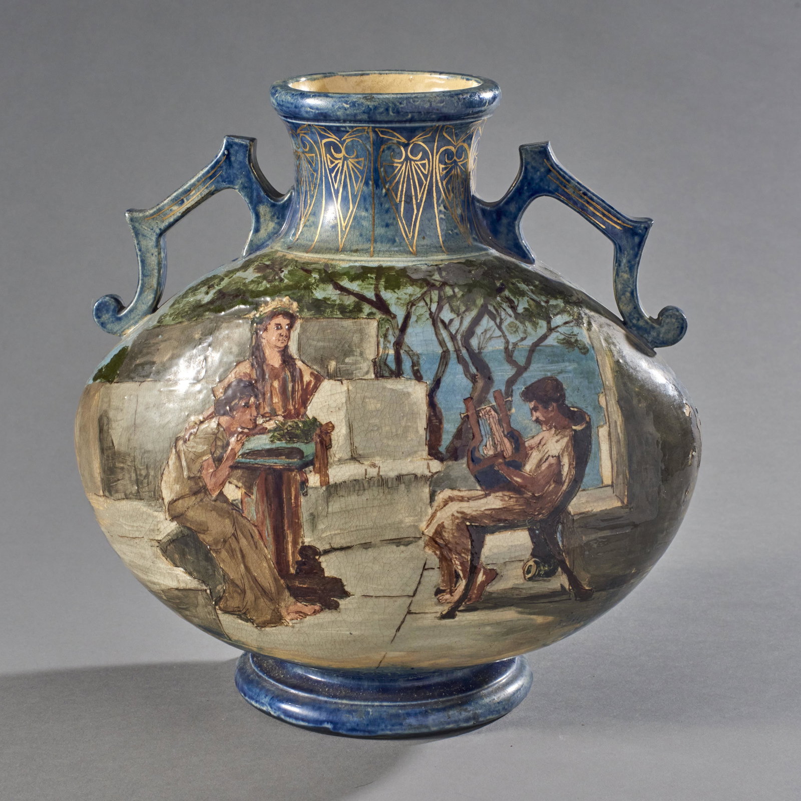 Pauline Pottery Grecian Mural Barbotine Vase: Barbotine vase with handles and enameled Grecian mural gilt accents. Stamped Pauline Pottery trademark on bottom. Condition: Overall good with some enamel loss on the side. Measures: 10 3/4" H x 11" W