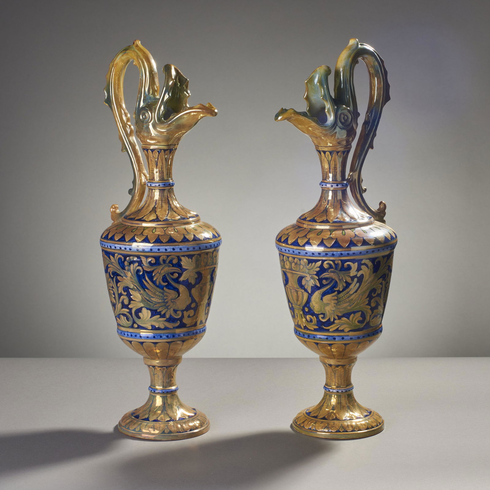 Luca Della Robbia, Gualdo Tadino Majolica Lustre Ewers: Pair of Luca Della Robbia Gualdo Tadino Italy Majolica lustre Serpent Ewers. Signed on bottom. Measures: 19" H x 6" Diameter