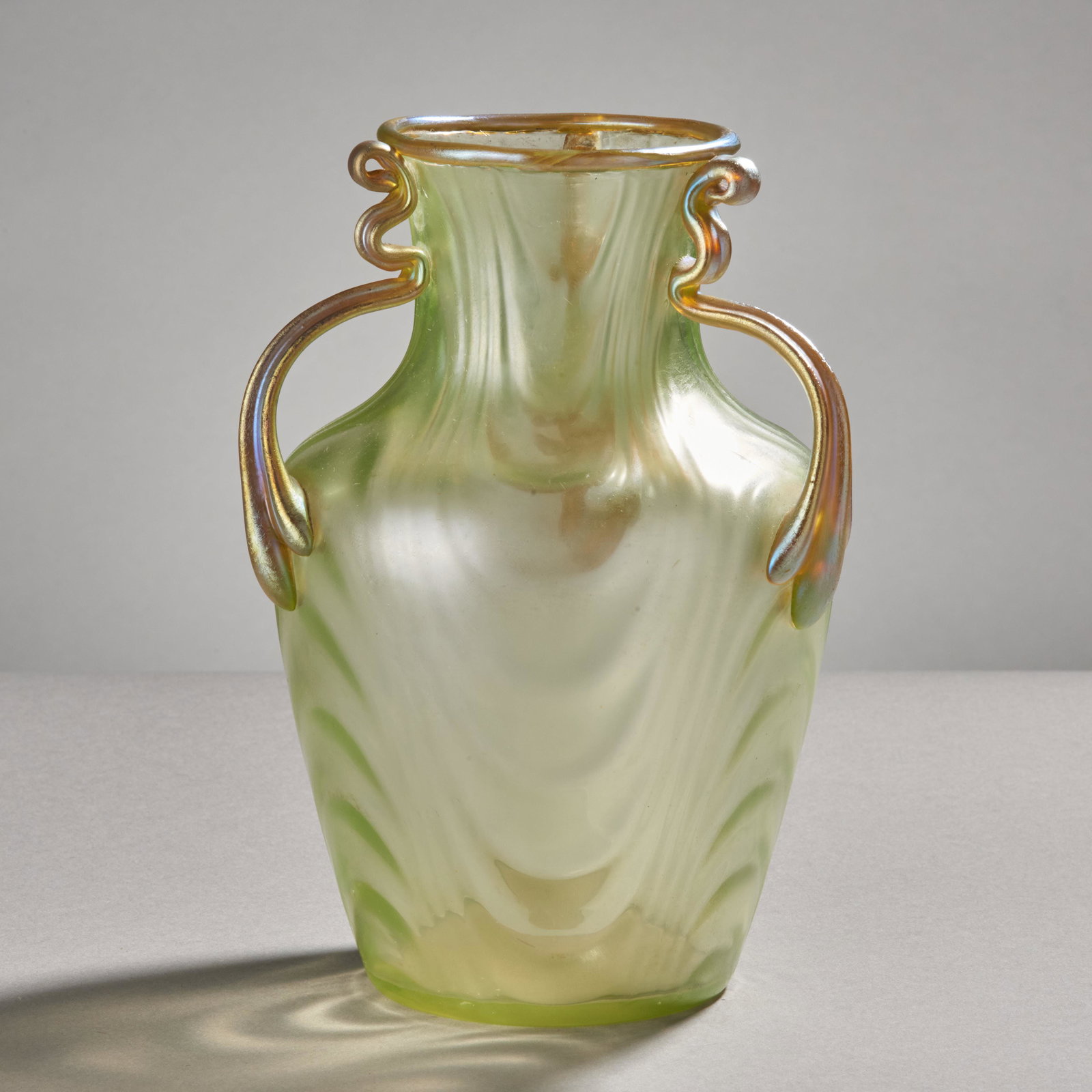 Loetz Art Glass 3-handled Vase: Loetz Art glass vase with 3 applied glass handles. Condition: crack (see images). Measures: Height: 8" Diameter: 5 1/2"