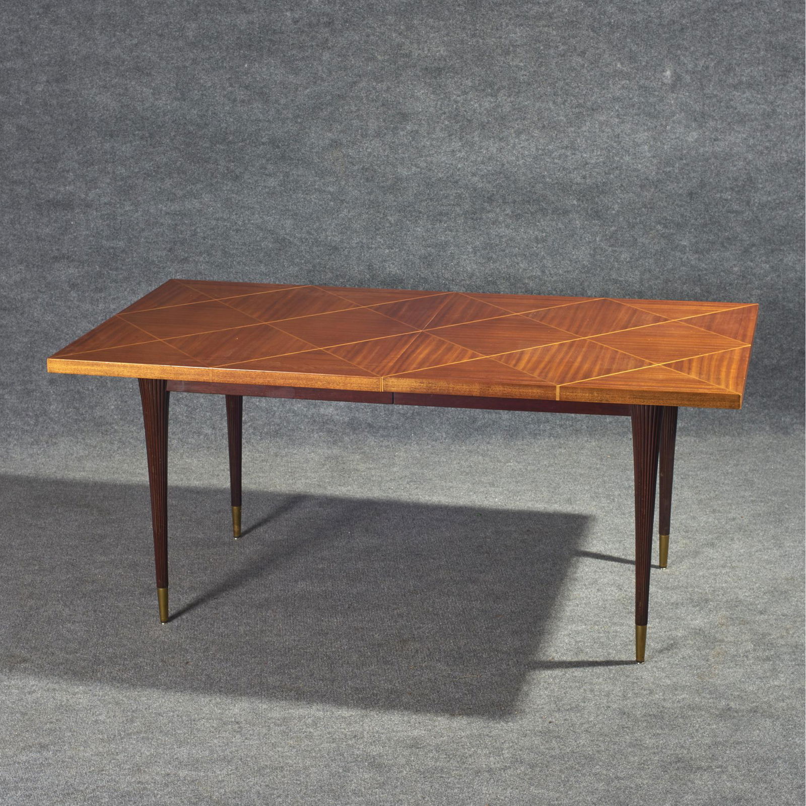 Tommi Parzinger For Charak Modern Dining Table: Tommi Parzinger for Charak Modern mid-century dining table with a mixed wood veneered parquetry diamond design rectangular top tapered reeded legs ending in tapered brass feet. Condition: Minor scratc