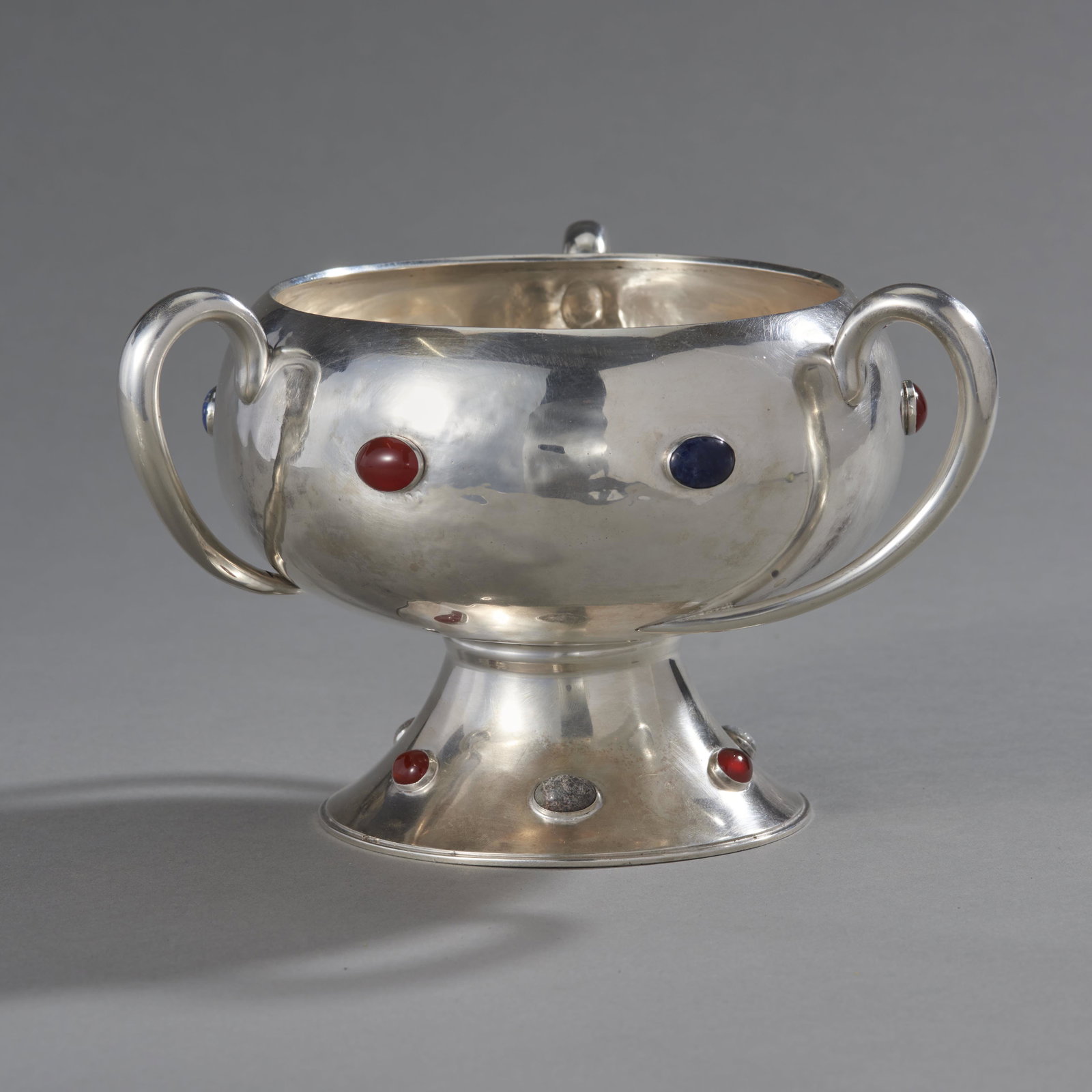 Jay Richard Attenborough Sterling & Jeweled Loving Cup: Jay Richard Attenborough sterling silver footed bowl with semi-precious stone decorations and 3 asymmetrical handles hallmarked on the bowl side: sterling Chester UK 1908 and stamped on the base. Cond