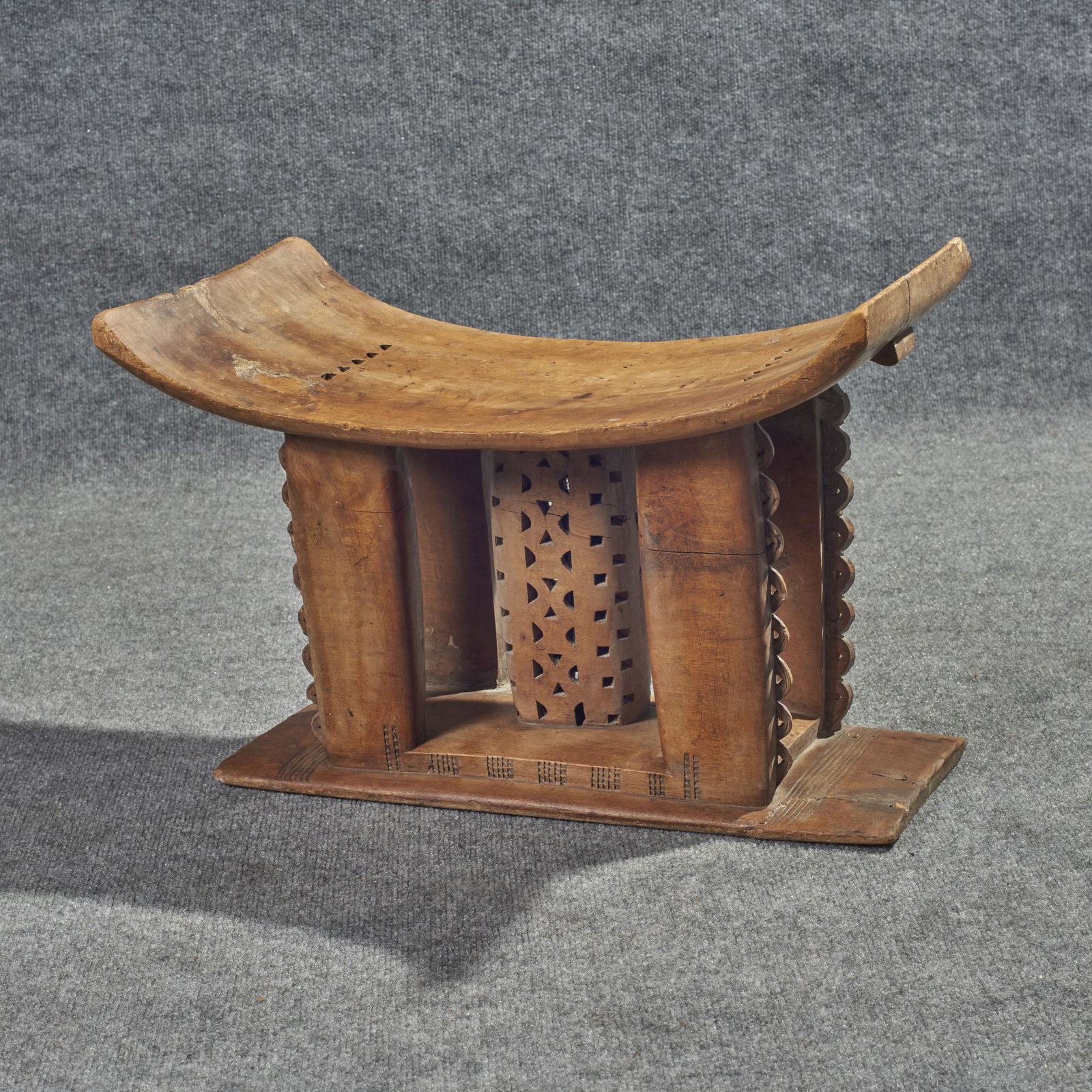 Ashanti African Carved Wood Stool: Ashanti African Stool Ghana carved wood with openwork design. Condition is good with wear appropriate for age. Dimensions: 16" H x 22 1/2" W x 8 3/4" D