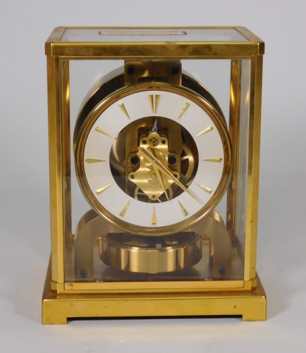 Le Coultre & Cie Atmos Clock: Le Coultre & Cie Atmos brass and glass clock, made in Switzerland. Retaining original locking label. Measures: 8 3/4" x 7" x 5 1/4".