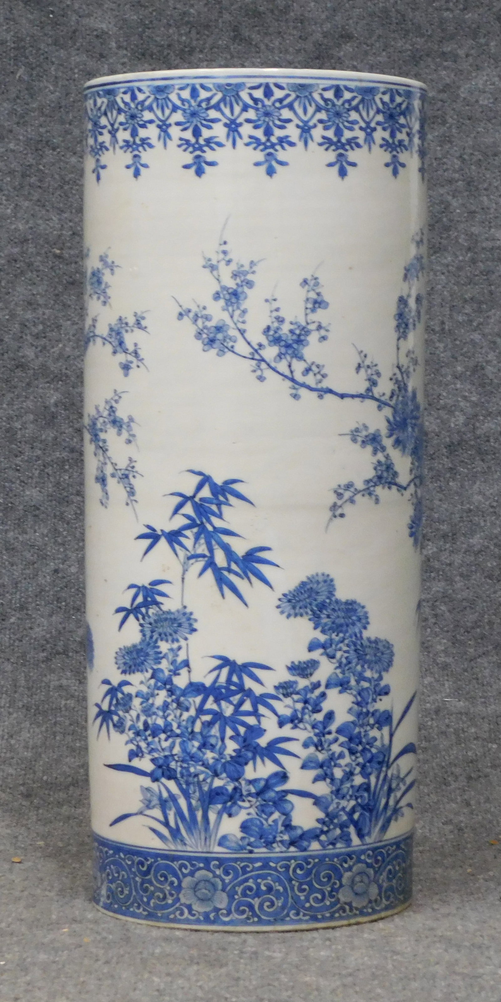 Japanese Blue and White Umbrella Stand: Japanese blue and white umbrella stand with floral decoration, late 19th - early 20th century. Dimensions: Height: 22 in. Diameter: 9.25 in. Weight: 277 oz.</