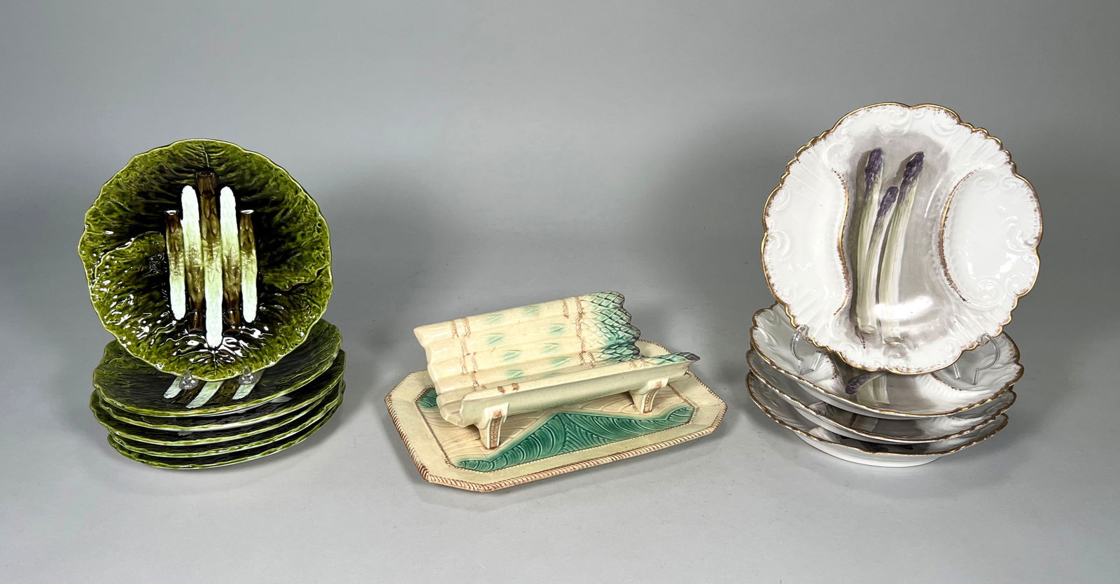 Group of Majolica Asparagus Motif Serveware: Group of asparagus French majolica serveware including: Six Julius Dressler, Austria, Majolica asparagus plates (8.5" diameter) Four Limoges asparagus plates painted by Durand (9.5" diamete