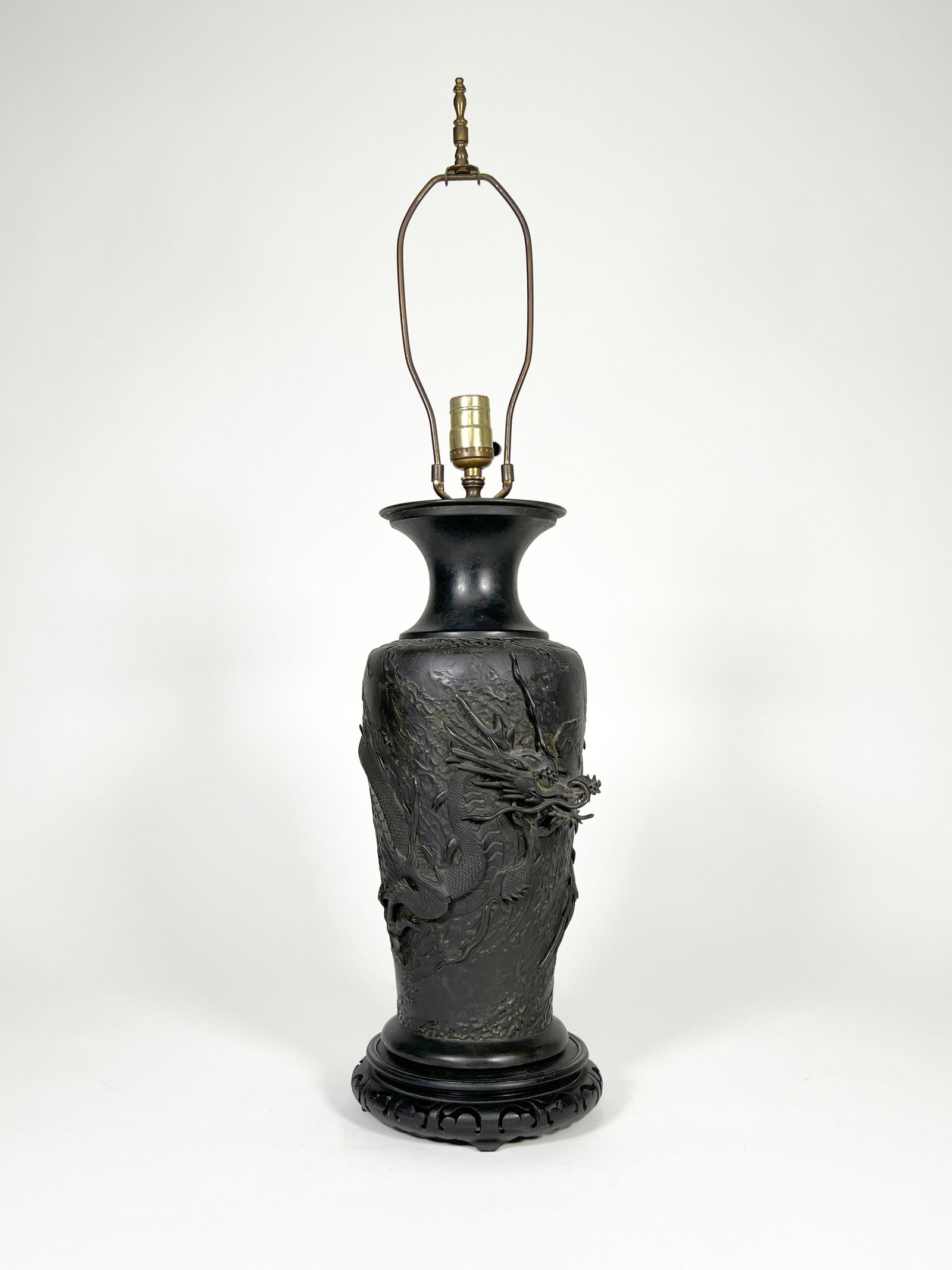Antique Japanese Bronze Dragon Vase Mounted as a Lamp: Antique Japanese bronze dragon vase, now mounted as a lamp, the baluster body cast in high relief with a writhing dragon amidst the clouds. Dimensions: Total Height: 31.5" Base Width: 7"