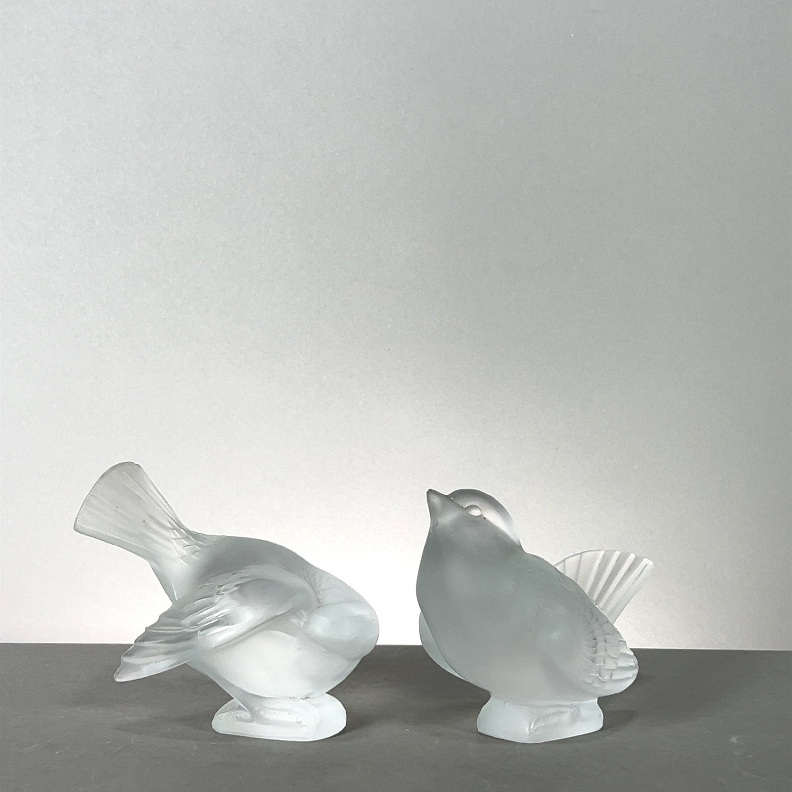 Pair of Lalique Frosted Crystal Sparrows: Pair of Lalique frosted crystal sparrows. Each approximately 4 inches in height and width. Combined weight 2 lb. 0.8 oz. Marked 'Cristal Lalique France' on the base.