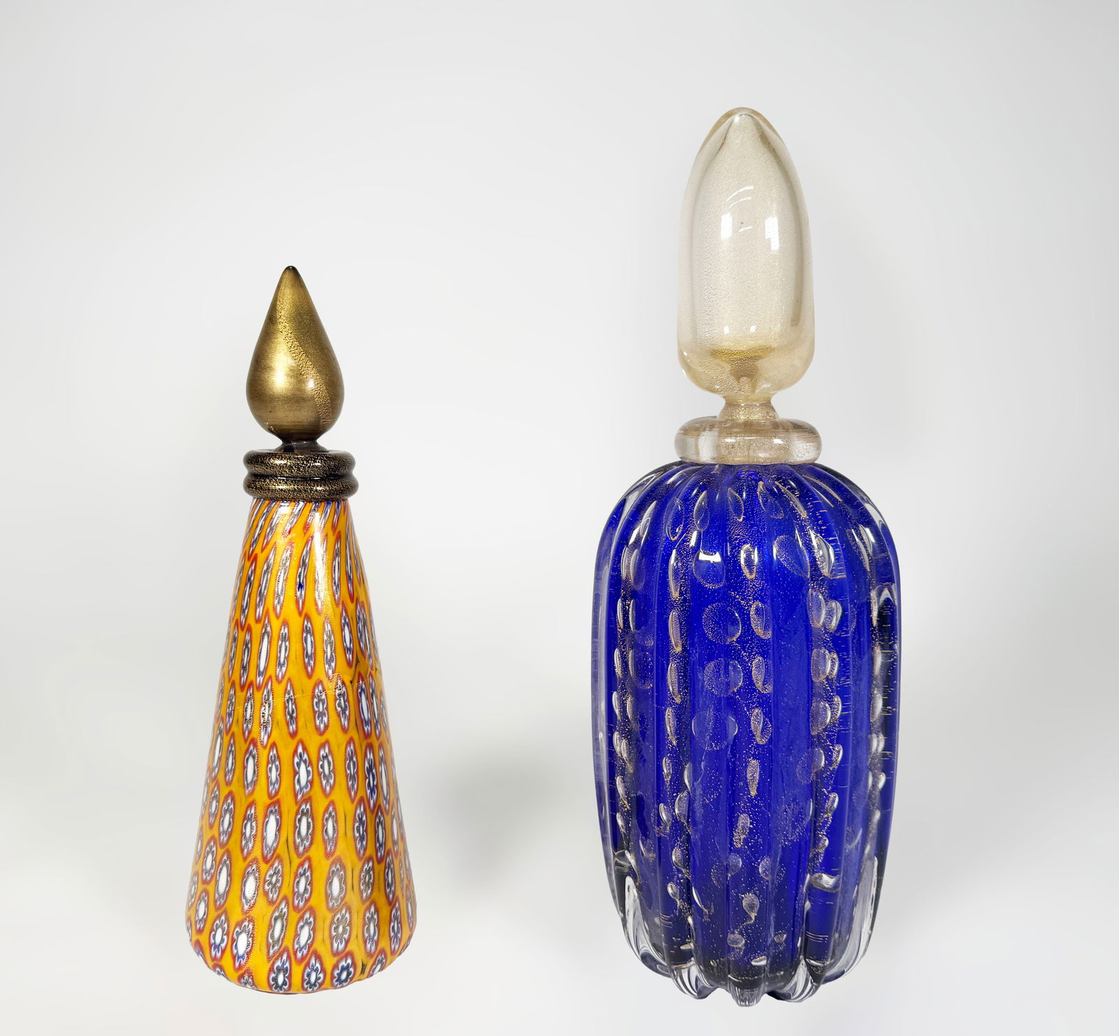 Gambaro & Poggi Murano Glass Decanters: Two Gambaro & Poggi Murano glass decanters, one millefiori and the other blue controlled bubble with gold aventurine. yellow: 11.25", 38.5 ounces blue: 12.25", 68.4 oz
