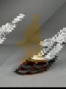 Japanese Okimono Fisherman with a Crane: Carved Japanese okimono figure depicting a fisherman standing beside a crane, holding a net and basket, on wooden stand. Dimensions: Height: 7 in. Width: 3.5 in.