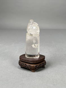 Chinese Carved Rock Crystal Seal: Rock crystal seal, the oval base surmounted by a finial carved in the form of mythical beast, raised on a fitted hardwood stand. Dimensions: Height: 4 in. (10.16 cm) Width: 2.5 i