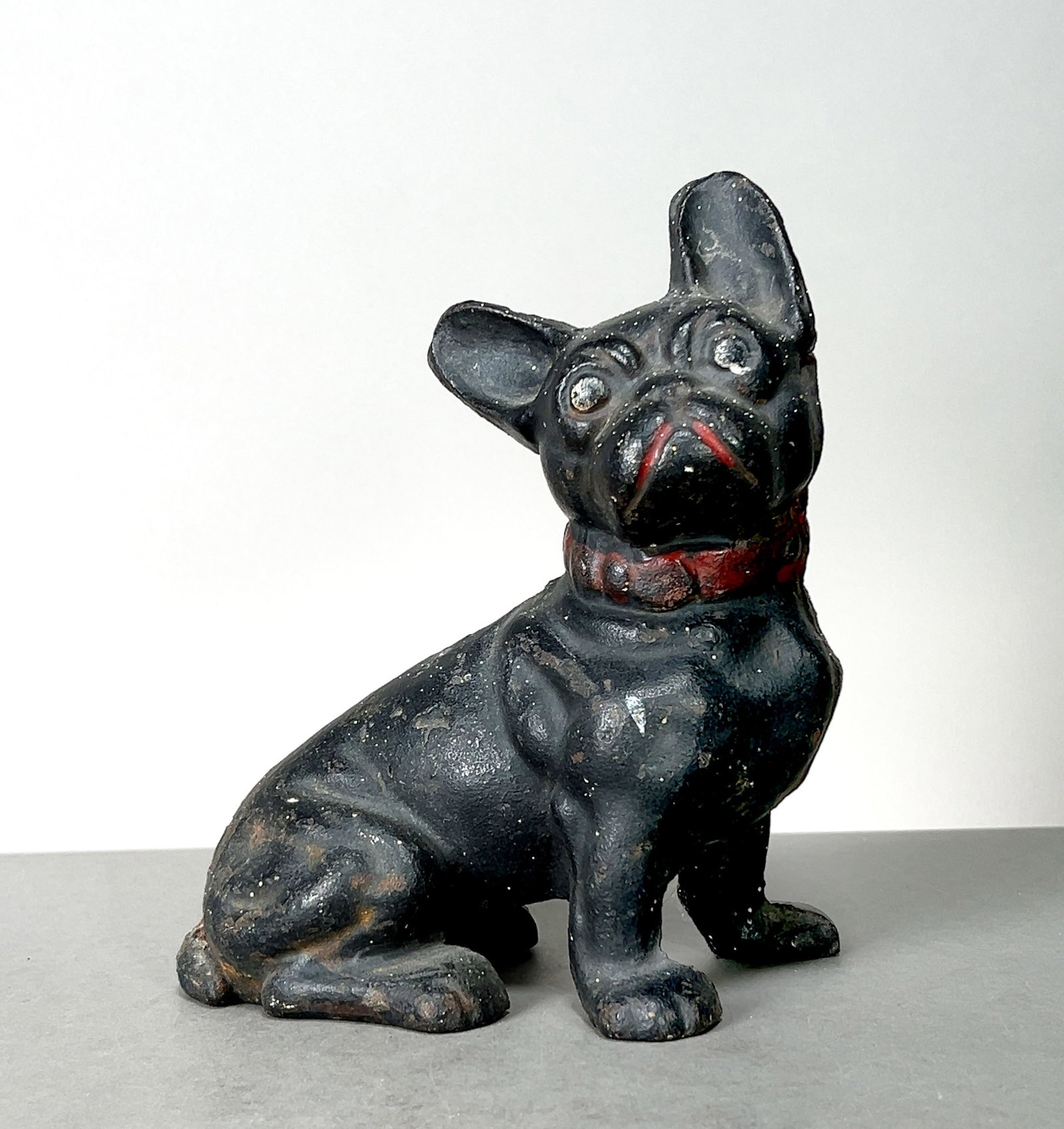 Hubley Cast Iron French Bulldog Doorstop/Coin Bank: Cast iron French Bulldog figurine designed as a doorstop or coin bank. Dimensions:Height: 7 inchesLength: 6 inchesWidth: 4 inchesWeight: 4 lb. 14.4 oz.