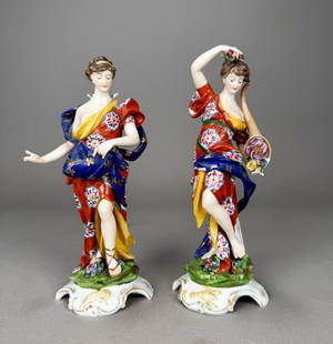 Pair of Volkstedt Figural Bud Vases: A pair of Volkstedt porcelain allegorical female figural bud vases, each marked on base.Dimensions: Height: 8 1/2"; Width: 3"