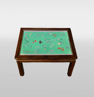 Chinese Famille Verte Porcelain Plaque Inset Table: Qianlong period Chinese rectangular wooden side table inset with famille verte porcelain plaque depicting a floral and bird motif, topped with glass.Dimensions:Height: 16 in.Width: 18.5 in.Depth: 25 i