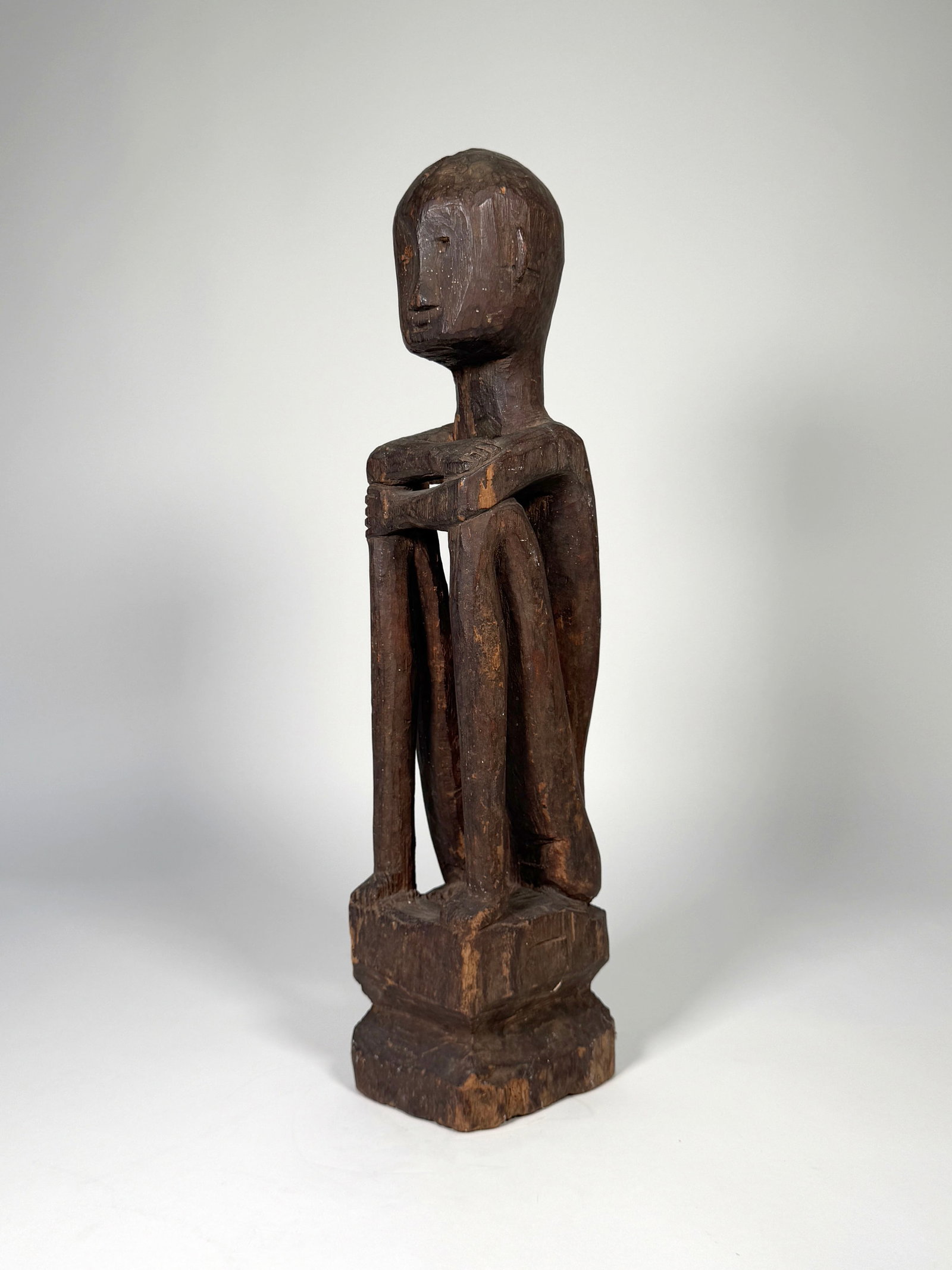Male Rice Deity Bulul, Philippines - Luzon, Ifugao: An early to mid 20th century male rice deity Bulul, Philippines - Luzon, Ifugao carved wood seated figure. 21"H, 67.4oz