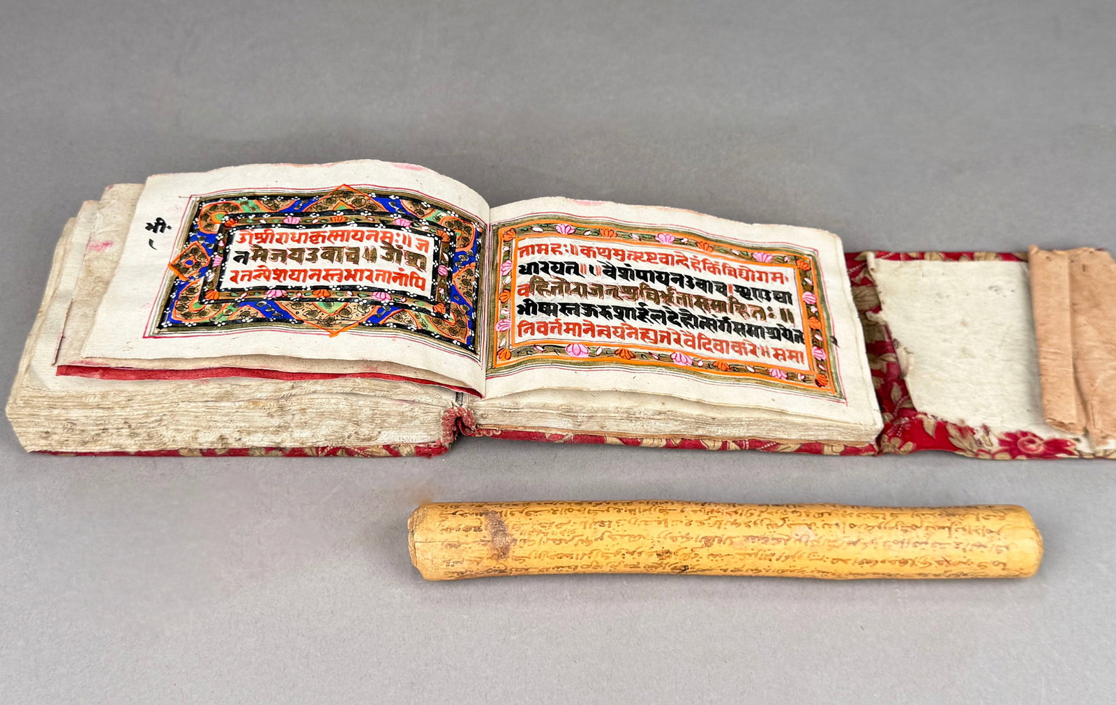 Bhagavad Gita Illuminated Hindu Manuscript and North African Staff with Contract: 19th century Bhagavad Gita illuminated Hindu manuscript with fabric cover and a North African cylindrical wooden staff with a contract in Arabic written around the staff. The book includes i