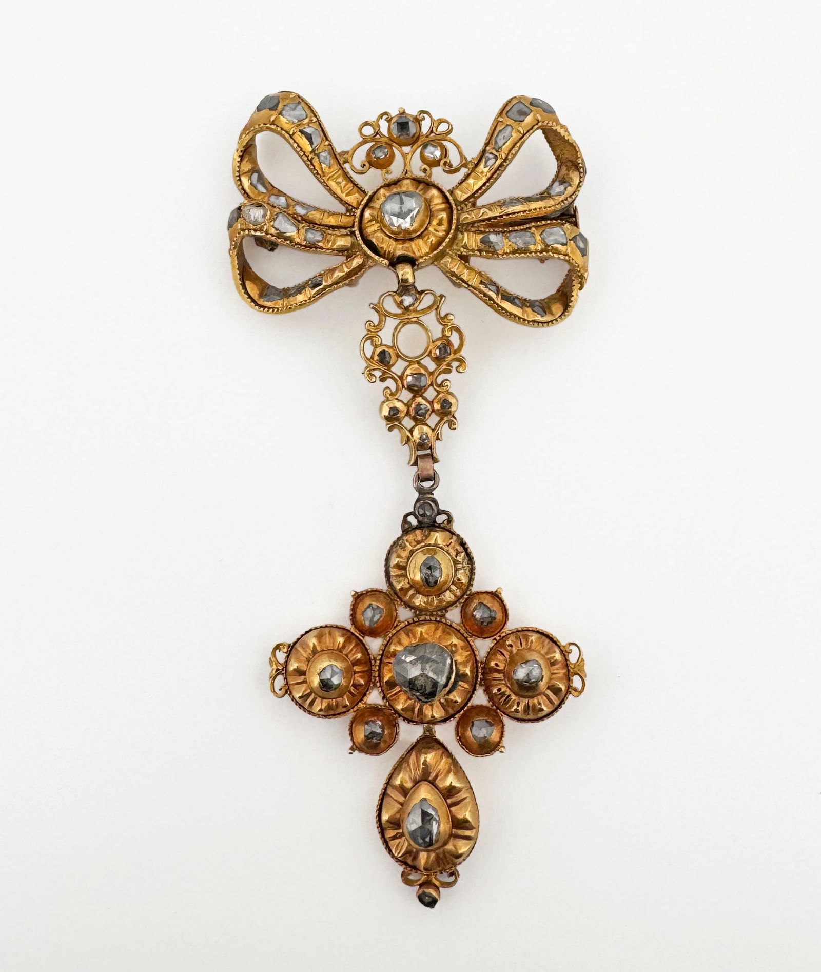18th Century 18k Spanish Diamond Lazo Pendant: 18th century Spanish 18k yellow gold with rose cut diamonds; three-part form with bow motif on top connecting to a cruciform pendant; later addition brooch pin to back 30.9g 97mm long Largest diamond: