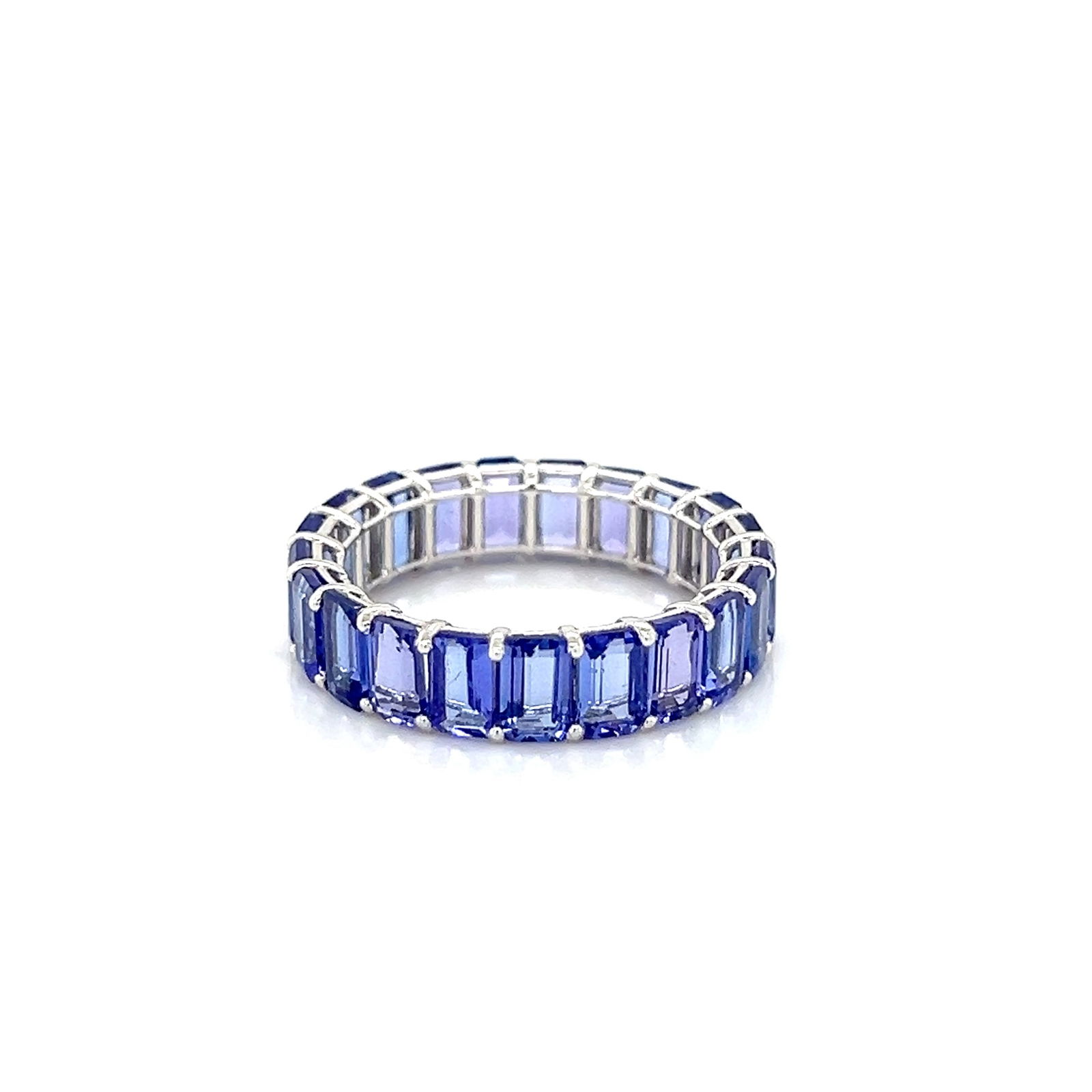 14k Emerald Cut Tanzanite Eternity Band: 14k white gold eternity band featuring emerald cut tanzanite, ~2.8 carats Weight: 2.8g Size: 6.75 Width: 5mm 