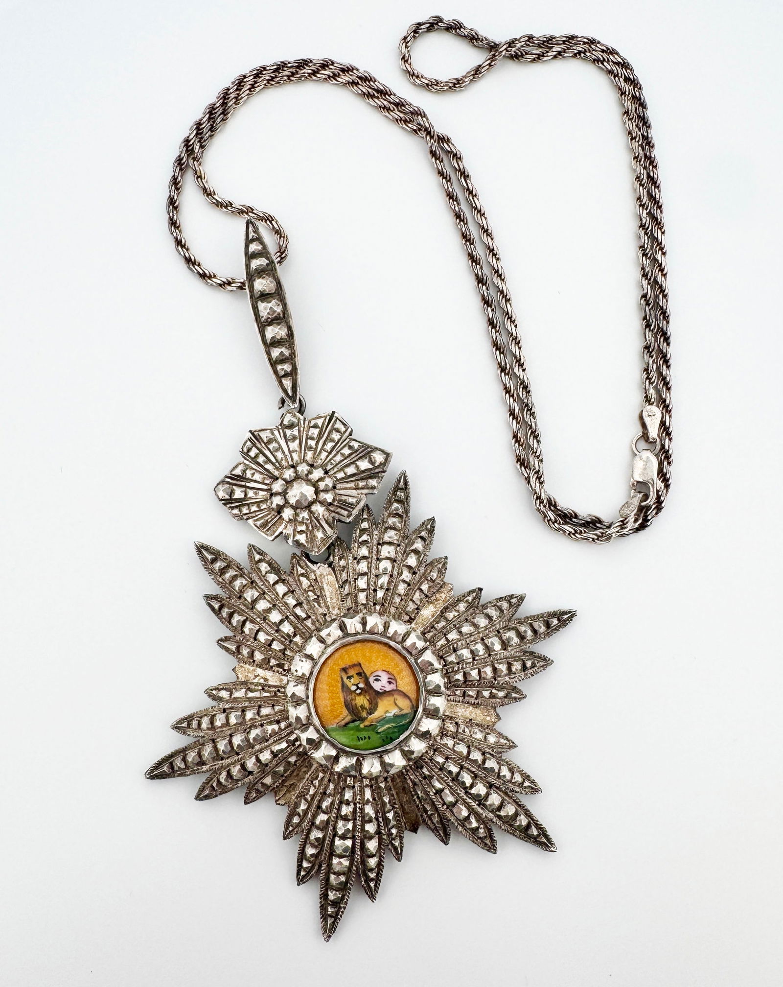 Silver Enameled Qajar Order of the Lion & Son Badge Necklace: Silver and enamel Iran Order of the Sun and Lion III Class Commander 1872 badge on a sterling silver chain 48.3g Pendant: 109mm long 24"