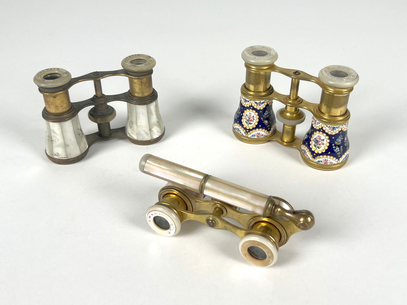 Three Pairs of Opera Glasses: Three pairs of opera glasses, including an Audemair Paris pair and a Lemaire Paris pair. Longest Length : 3"Total weight: 19 oz.