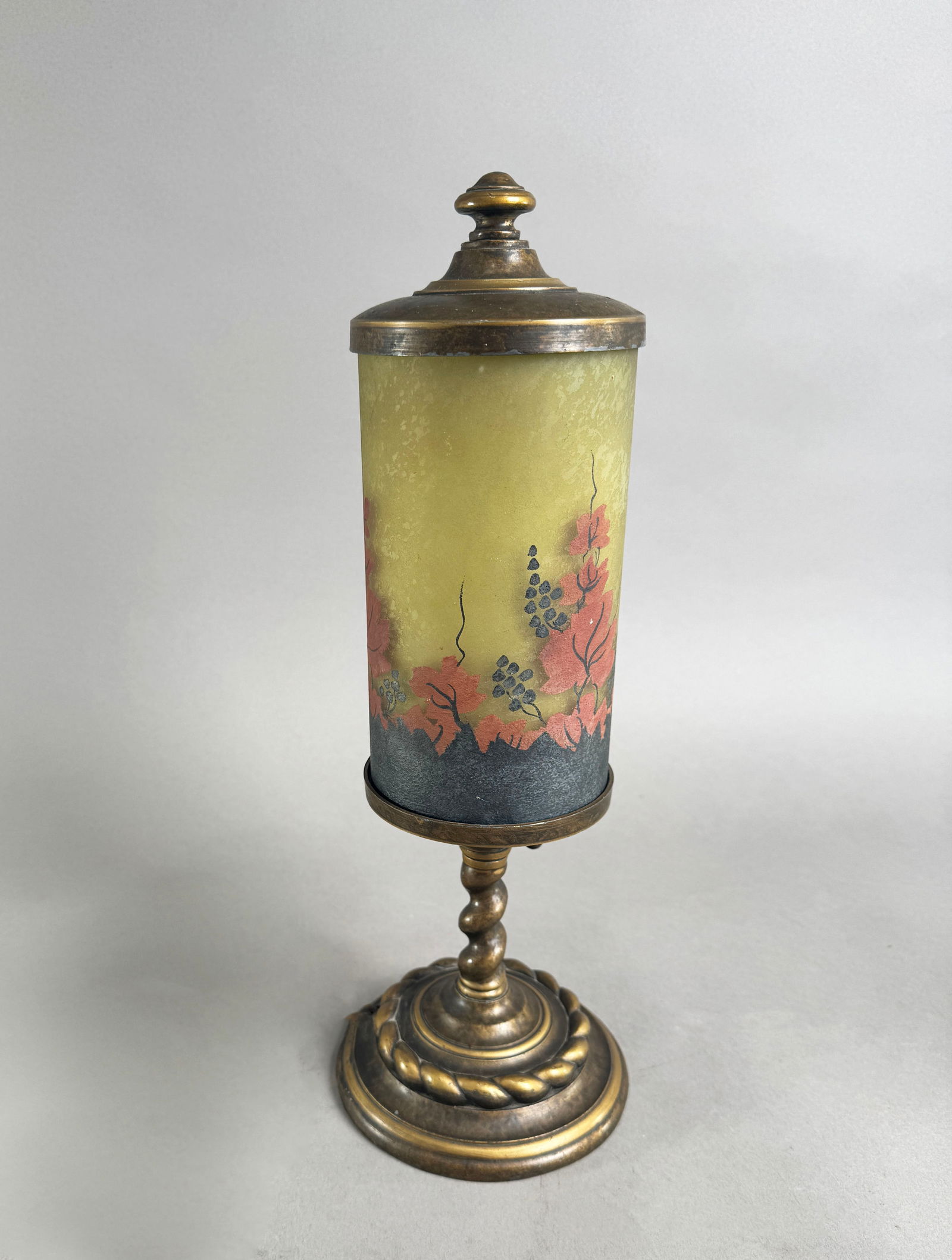 Handel Mantel Lamp with Floral Shade: A Handel Company mantel lamp featuring a cylindrical glass shade with floral decoration and original tag on the base. Shade is painted on the surface of the glass and has no markings. 