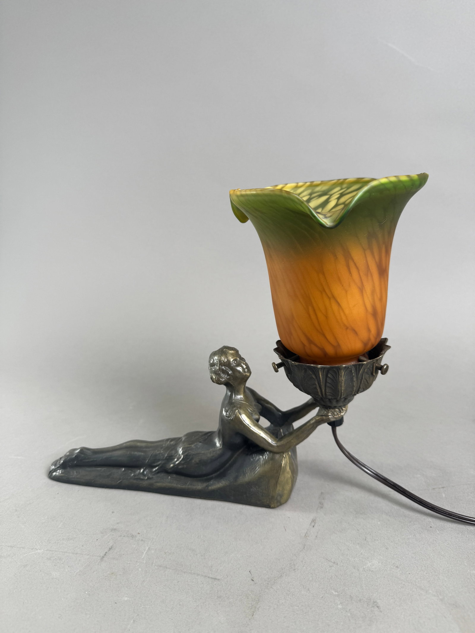 Art Nouveau Figural Lamp: Art Nouveau table lamp with floral blown glass shade supported by a female figure. Height 9.25” base 8.5” Weight: 49 oz