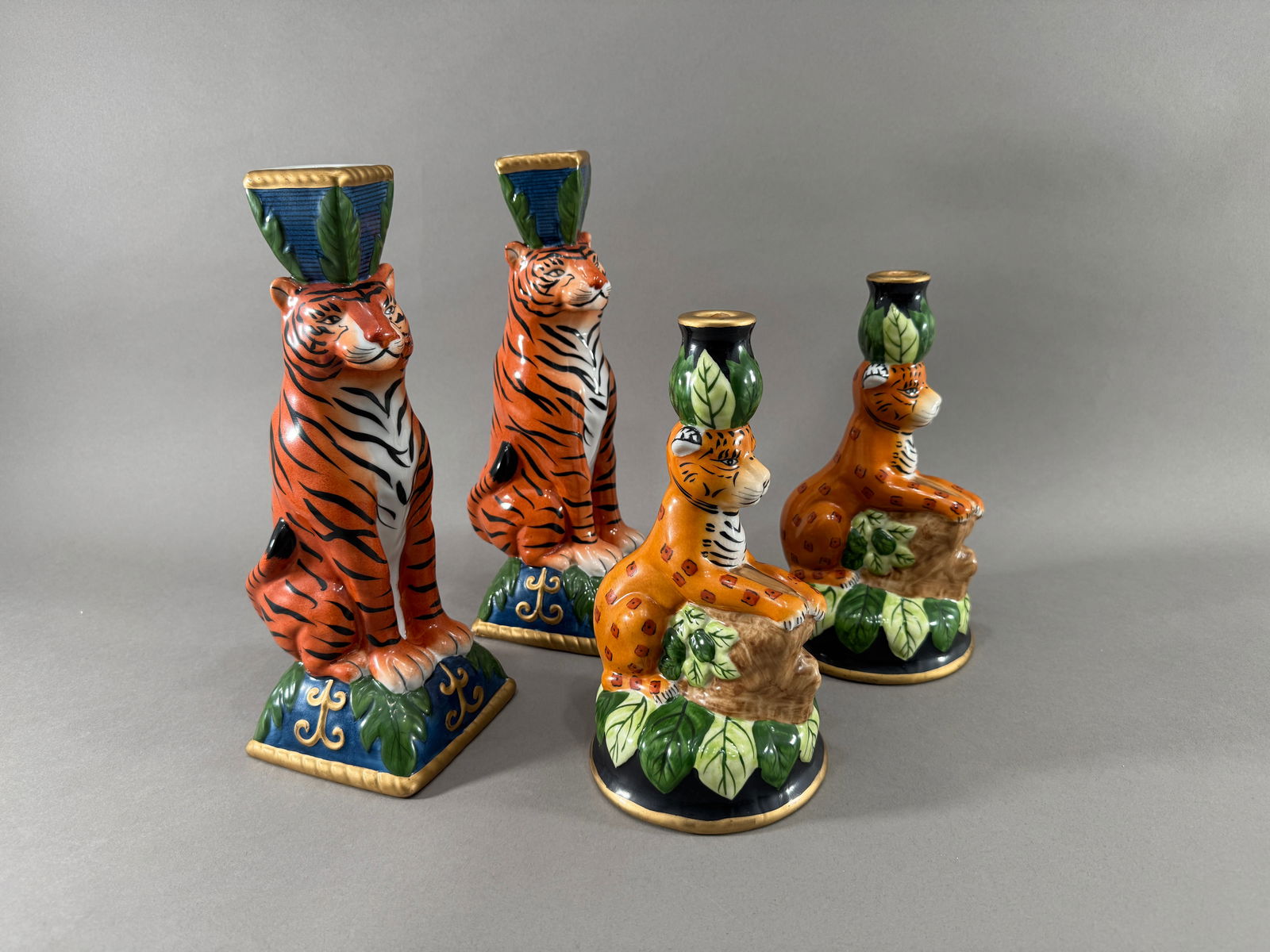 Two Pairs of Candlesticks: Two pairs of candlesticks, one with tigers and the other with cheetahs Height : 12 1/2"