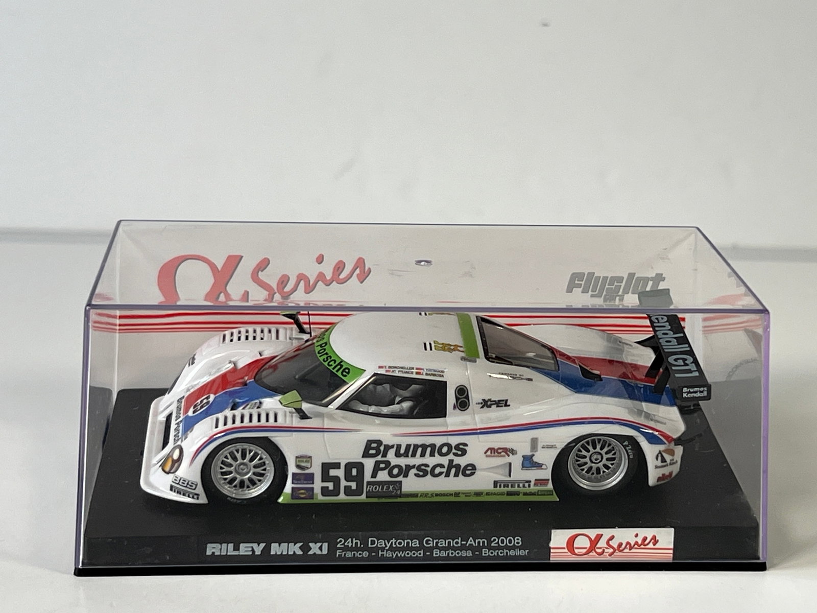 Flyslot Riley MK XI 24h Daytona Grand-Am 2008 #59 1/32 Slot Car: Riley MK XI 24h Daytona Grand-Am 2008 France - Haywood - Barbosa - Borcheller #59 Brumos Porsche 1/32 Slot Car. Reference #M02101, with original case. Case length: 6.5''. Weight: 7 oz. 