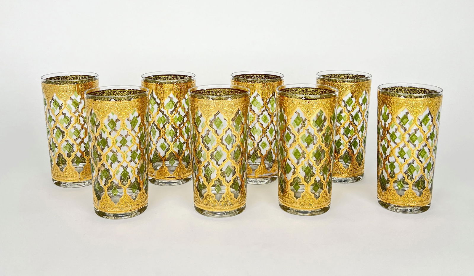 Set of Eight Culver Valencia Highball Glasses: Set of eight signed Culver Valencia highball glasses with 22k gold and green lattice design. Each glass measures approximately 5.5 x 3 inches.