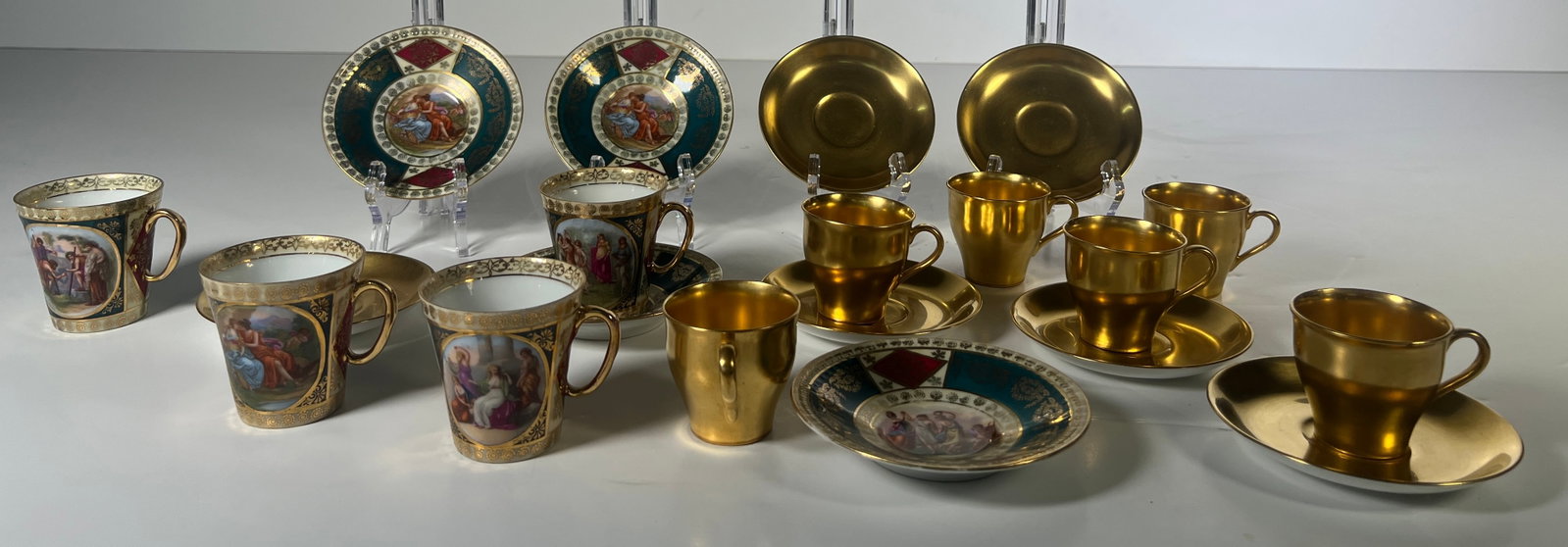 Antique Mixed Demitasse Cup and Saucer Set: Collection of antique demitasse cups and saucers. Includes gold tone cups and saucers, and cups and saucers with portrait medallions. Saucers measure approximately 5 inches in diameter. Cups are appro