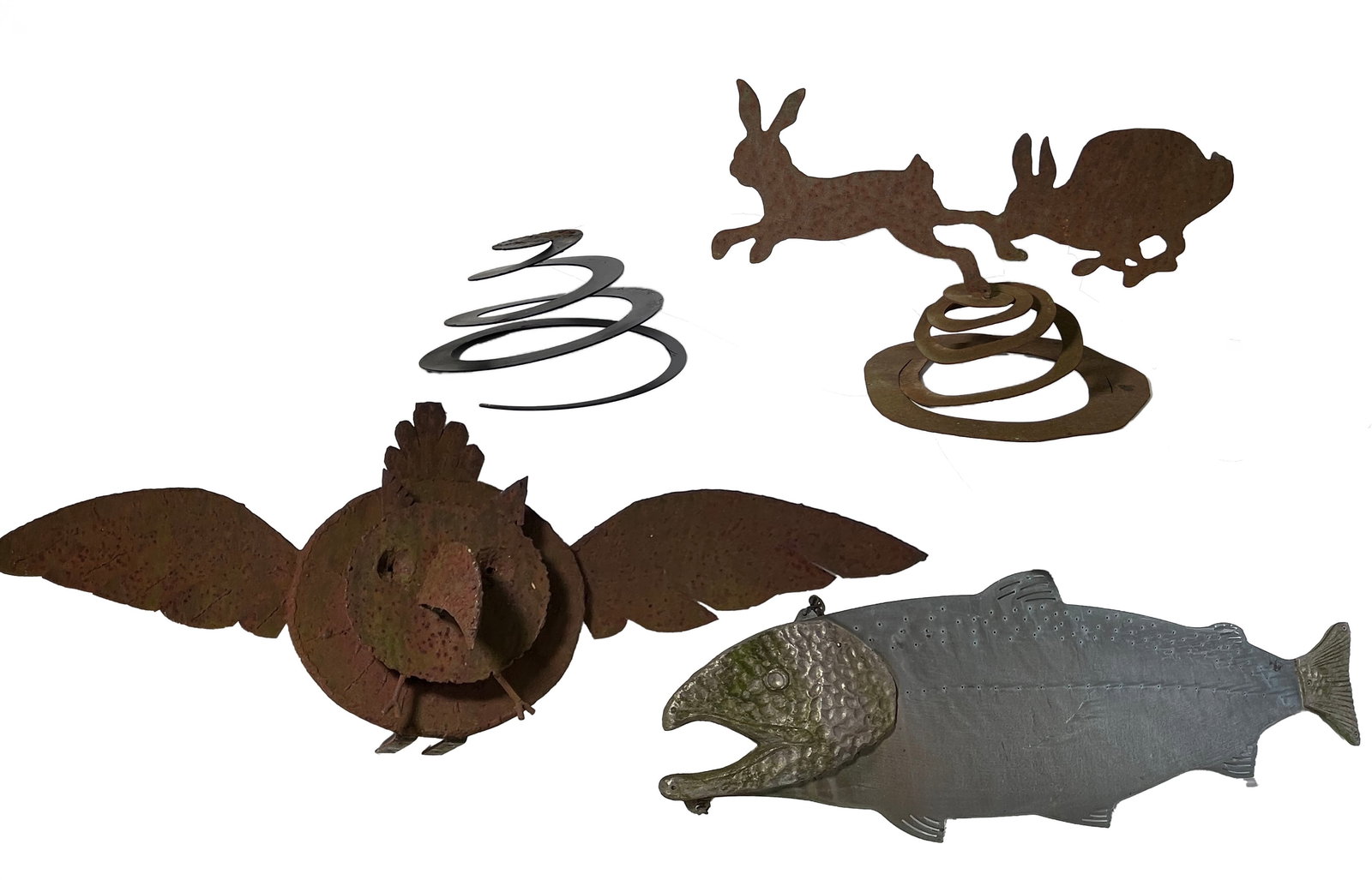 Four Outdoor Metal Sculptures: Group of four outdoor sculptures including a spring, two rabbits on top of a spring, an owl, and a fish The largest item is 36 inches long.