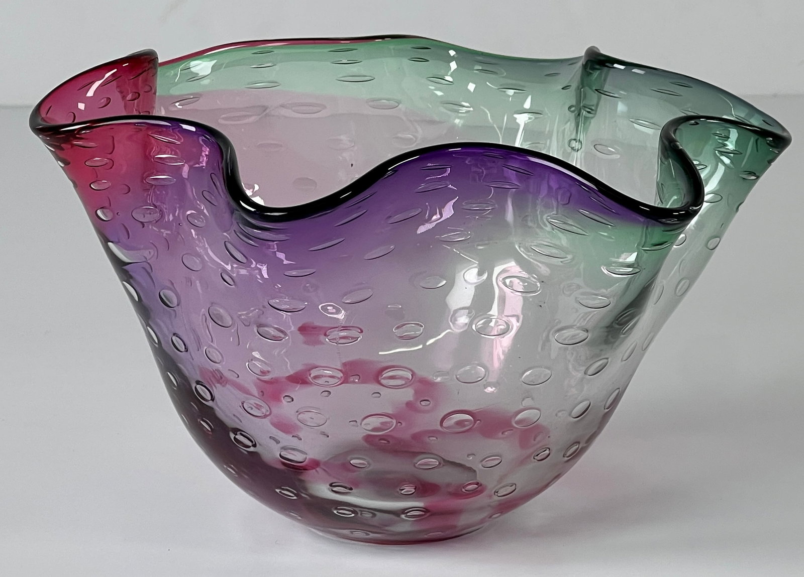 Adam Jablonski Art Glass Bowl: Art glass bowl signed by Polish artist Adam Jablonski. Features a ruffled rim and internal bubbles. The colors transition from red to purple to green. Dimensions: Height - 5 1/4"; Width - 9"