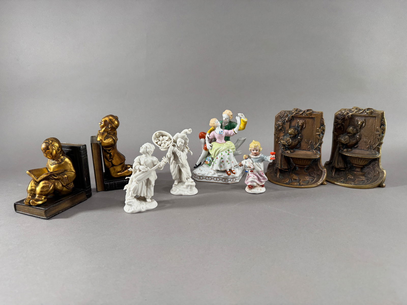 Collection of Figurines and Bookends: A collection of decorative figurines and bookends. Includes porcelain figurines and figural bronze bookends. Various sizes and styles. See images for details.
