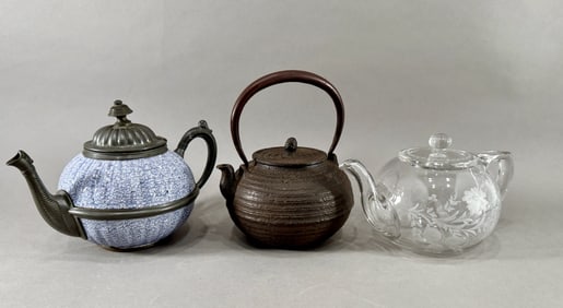 Three Decorative Teapots: Ceramic, Cast Iron, and Glass