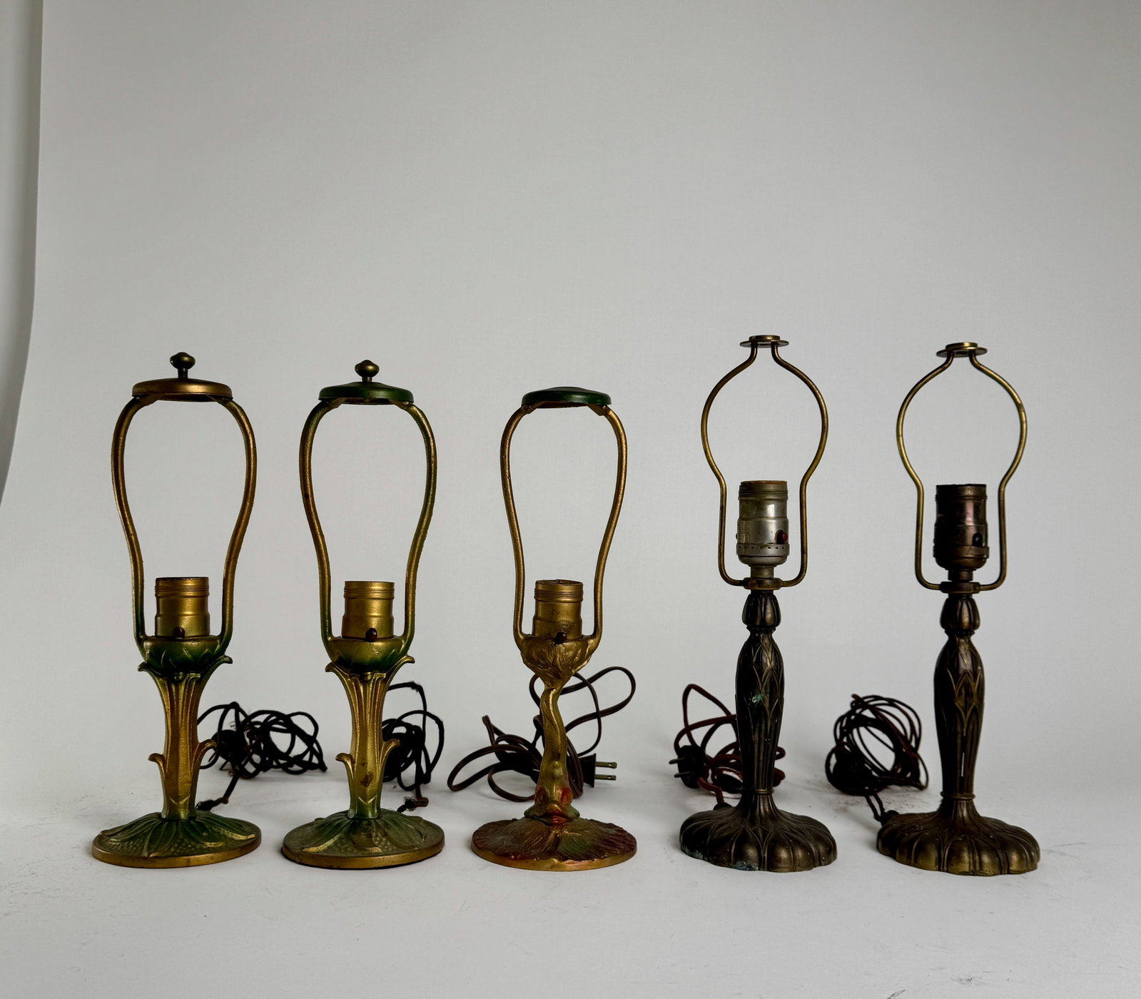 Set of Five Vintage Lamp Bases: A set of five vintage lamp bases. The bases are made of metal and feature a variety of designs. Tallest: 13.5''.