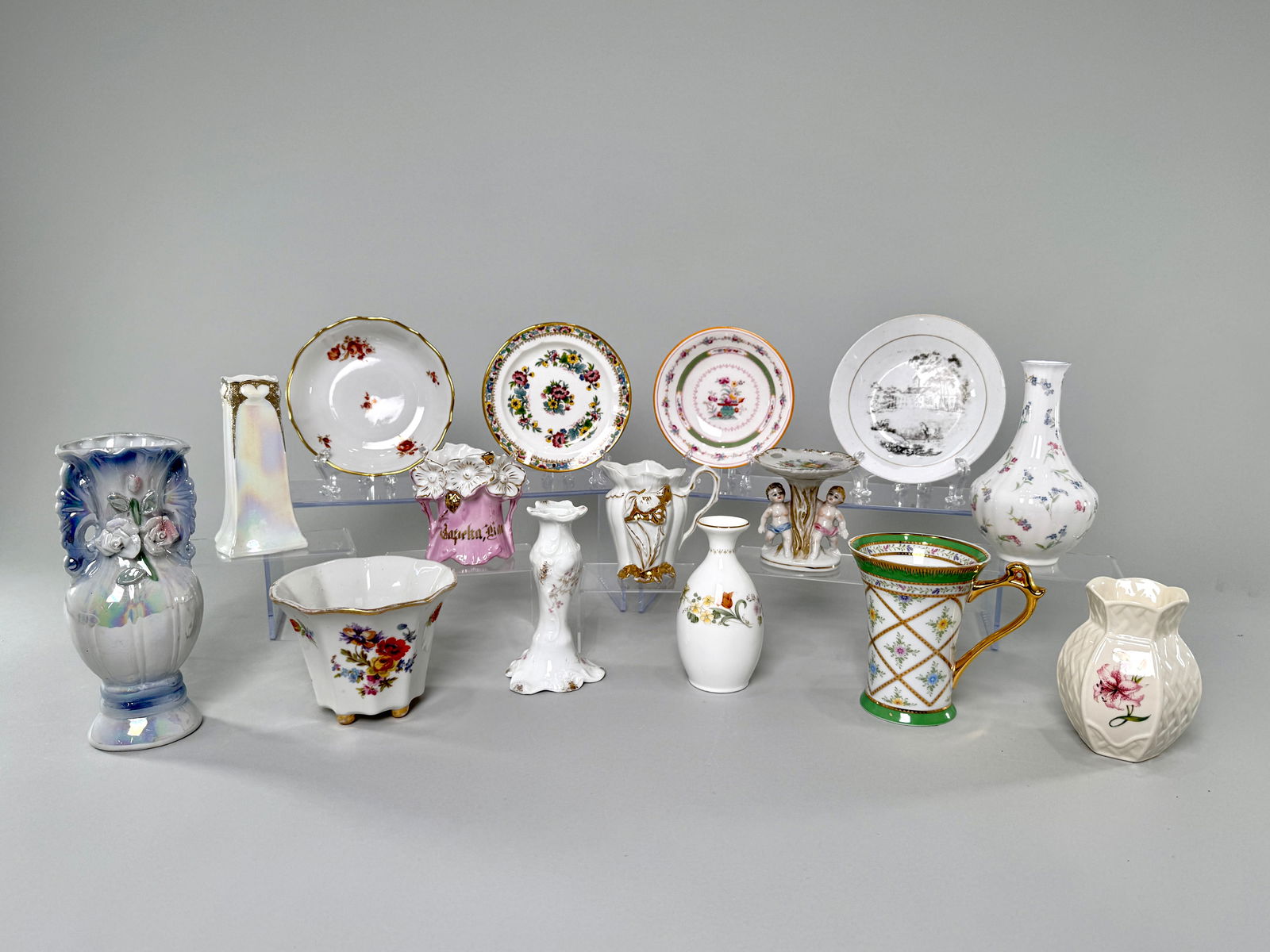 Collection of Decorative Porcelain Vases and Plates: A collection of decorative porcelain items, including vases, plates, and a Betson cherub dish. Floral motifs and gold accents are present on many pieces. Tallest item measures 7.75 inches, total weigh