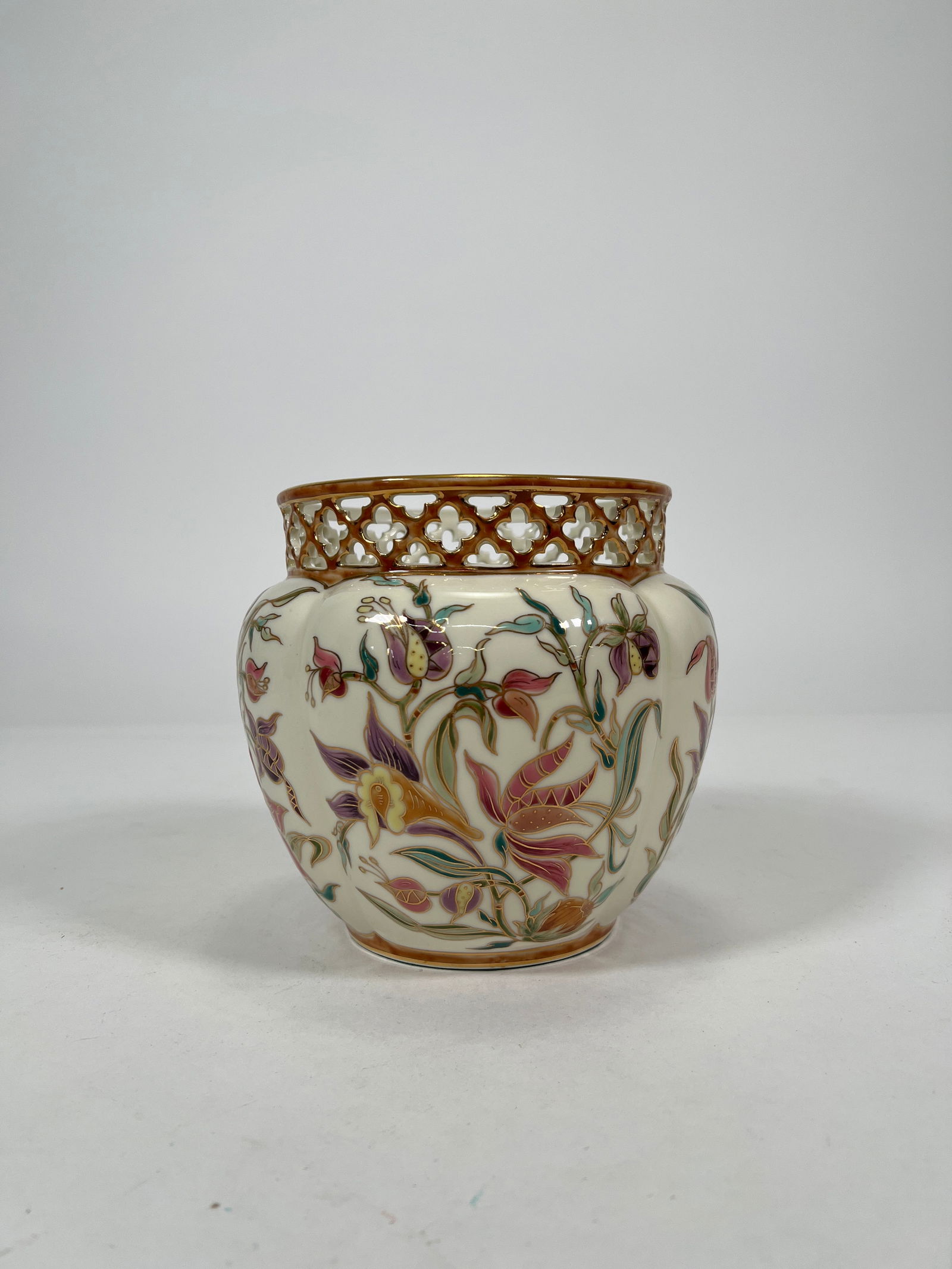 Zsolnay Hungary Hand-Painted Porcelain Vase, Lattice Rim: Zsolnay Porcelain Manufacture of Hungary vase featuring hand-painted floral motifs in pink, purple, and green with gold highlights. The upper rim has a delicate reticulated design with gilt details. M