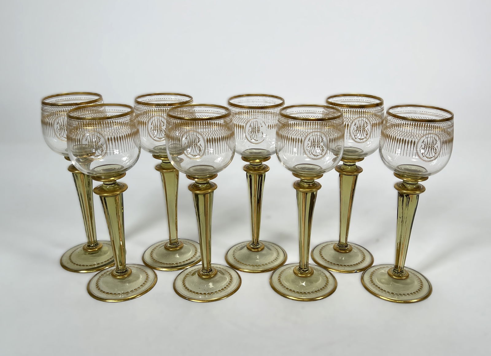 Set of 8 Vintage Cut & Gilt Cordial Glasses: Elegant set of 8 vintage cordial glasses with cut glass and gilt decoration. Each glass features a delicate lattice pattern, a central monogram design, and gold accents on the rim, stem, and base. Ide