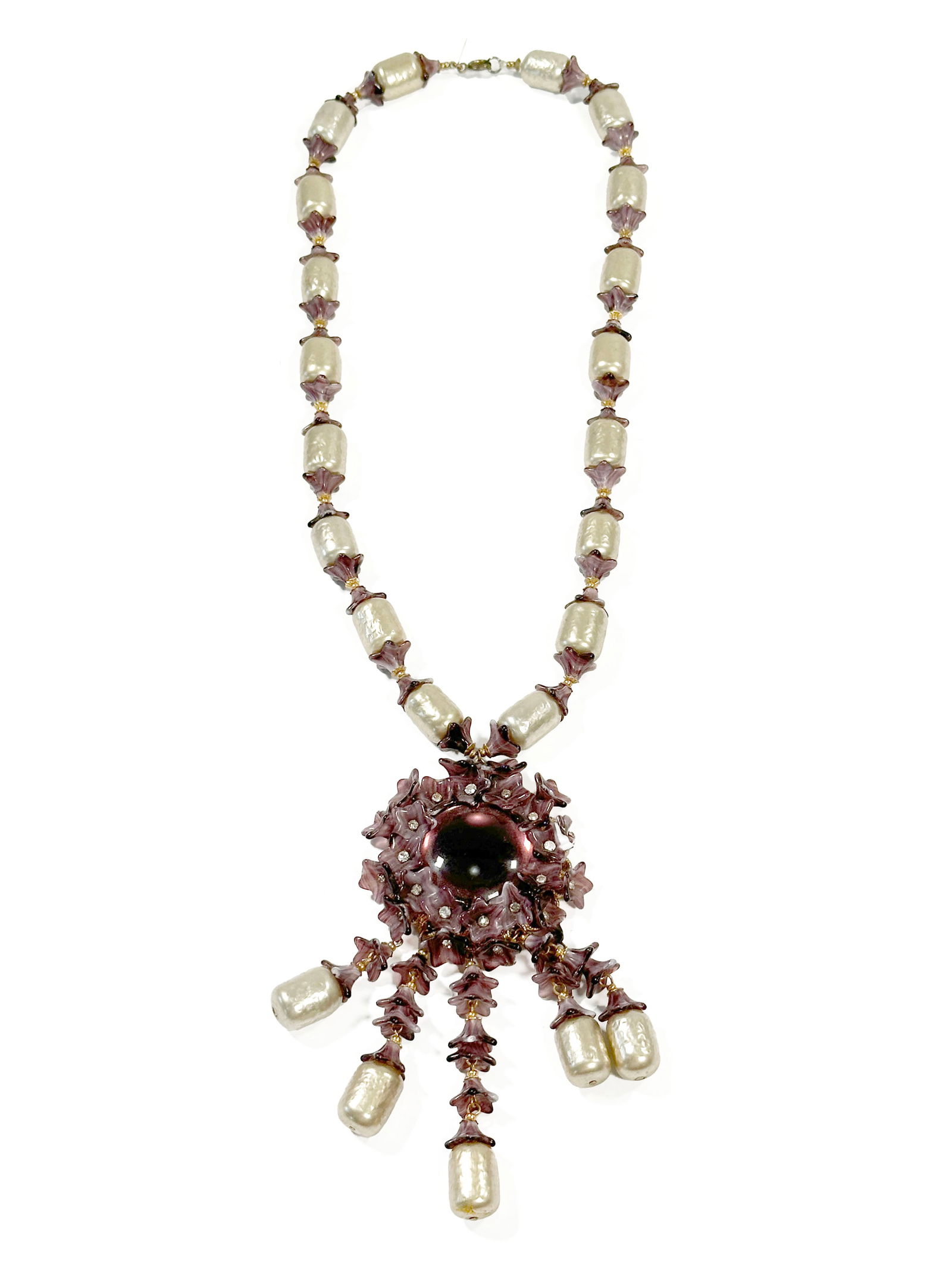 Miriam Haskell Purple Floral & Faux Pearl Necklace: Miriam Haskell necklace featuring pearlescent barrel beads and a purple glass floral pendant. The necklace is signed Miriam Haskell on the hangtag. Measures 17.75" long and weighs 79.8g.