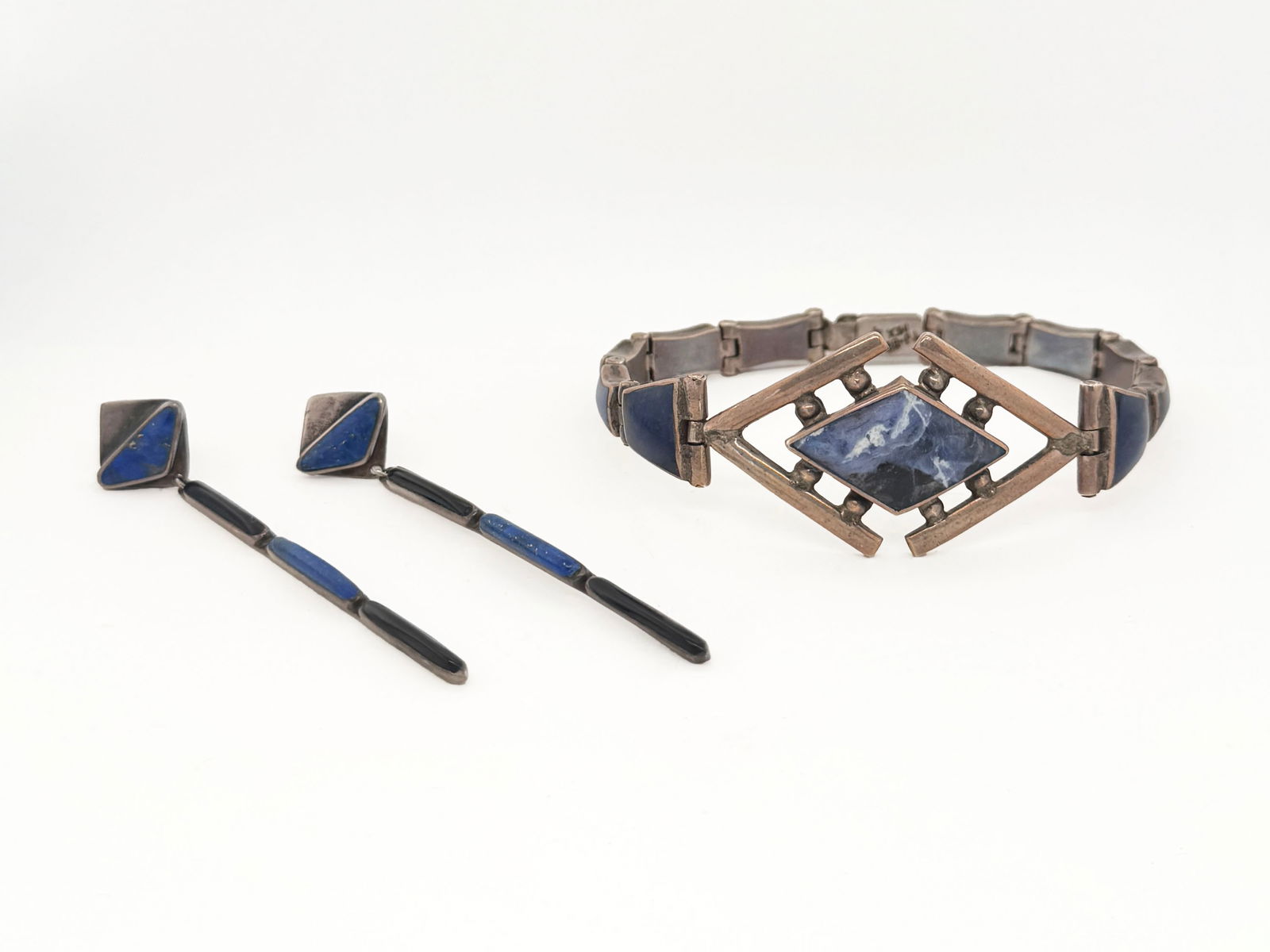 Mexican Sterling Silver Bracelet and Earrings: Sterling silver and lapis earrings and sterling silver and sodalite bracelet.The bracelet is approximately 3 inches long, and the earrings are 2.75 inches long. The set weighs 45.4g. The pieces are