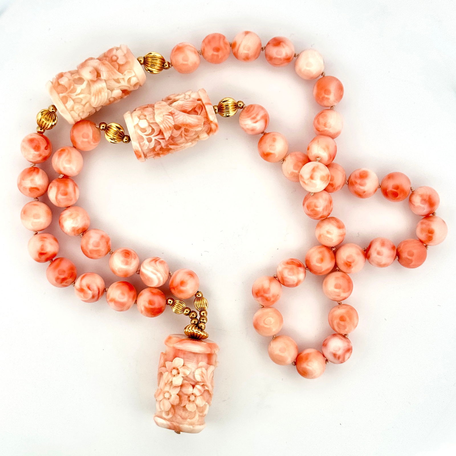 10k (?) Carved Coral Beaded Necklace: A carved coral necklace with 10k (?) gold beads.140.4g27"