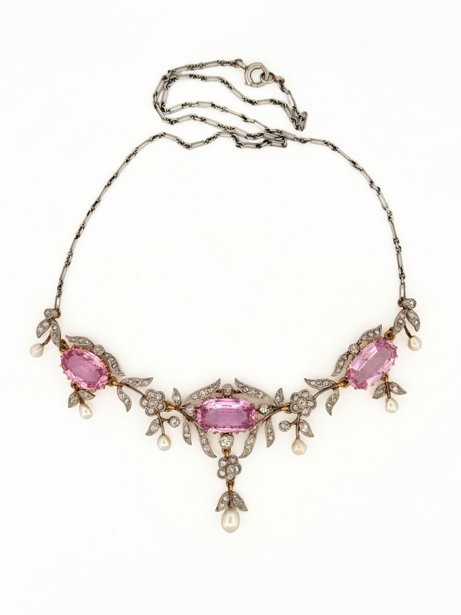 Antique Pink Topaz, Diamond, and Pearl Necklace: Antique necklace featuring three pink topaz stones, accented with diamonds and pearls. The necklace has a delicate chain and ornate metalwork. 14k+ 14.6g 31" total length