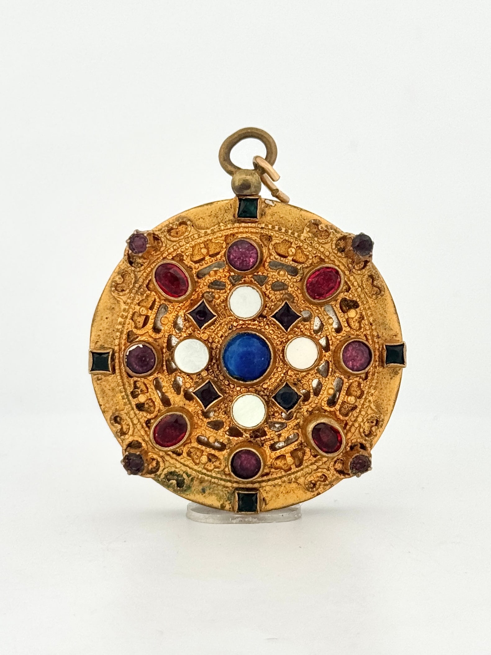 Czech Glass Gemstone Brass Locket Pendant: Vintage gold tone locket pendant featuring a central blue stone, mother of pearl, and red gemstones. Measures approximately 1.5" x 1.75" and weighs 25.7 grams. Locket opens to reveal a