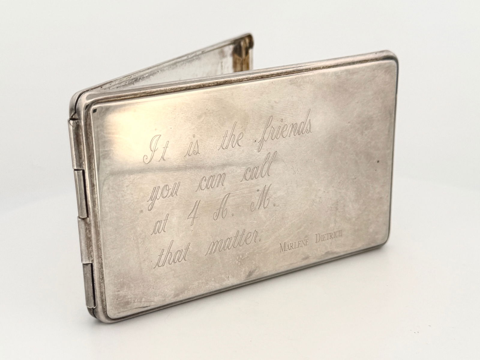 Sterling Marlene Dietrich Engraved Card Case: Sterling silver card card with quote by Marlene Dietrich: "It is the friends you can call at 4 A.M. that matter." Includes address book insert. Measures approximately 3 3/4" x 2
