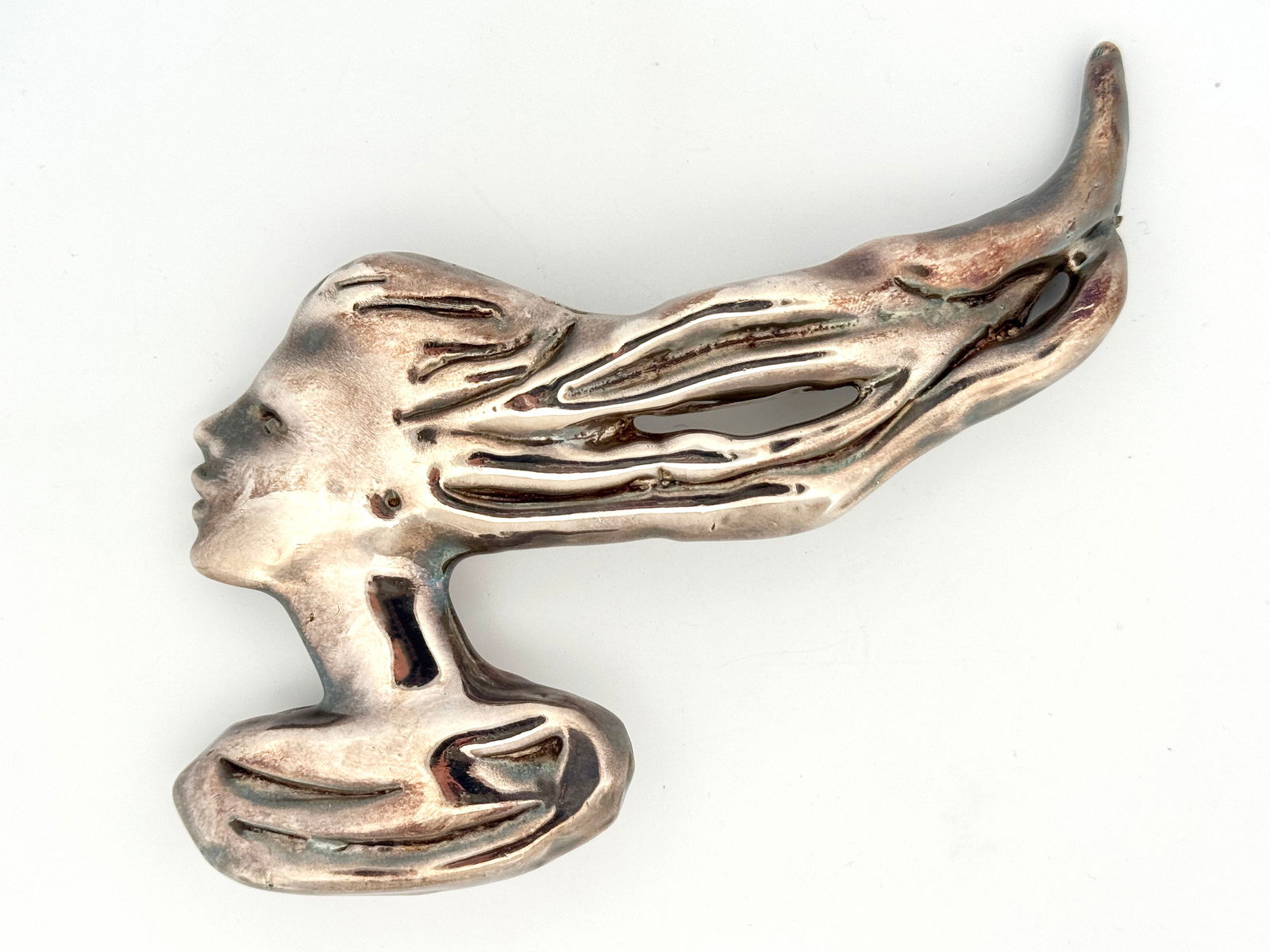 Yaacov Heller Sterling Silver Brooch: A sterling silver brooch of a woman with flowing hair designed by Yaacov Heller, signed on reverse.47.1g4.5" x 3.25"